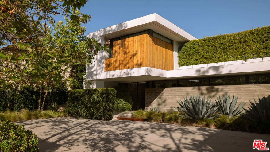 Nestled in the highly sought-after Riviera neighborhood of Pacific Palisades, 748 Amalfi Drive offers a masterful blend of bold architectural design and refined luxury. This California Modern estate, completed by renowned firm O+L, spans three expansive levels and is thoughtfully designed to harmonize with its lush surroundings, creating a seamless connection between indoor comfort and outdoor living. With nearly 9,000 square feet of interior space, this home provides six spacious bedroom suites and eight elegant bathrooms. As you enter, a dramatic cantilevered entryway and floating staircase framed by a soaring concrete feature wall set the tone for the home's striking aesthetic. Inside, clean lines, open living areas, and walls of retractable glass allow natural light to flood the space, offering unobstructed views of the beautifully landscaped grounds. The kitchen is a chef's dream, featuring sleek cabinetry, high-end Miele appliances, and a large central island perfect for entertaining. Additional features include a private home theater, a temperature-controlled wine cellar, a sauna, and a sophisticated home office, ensuring every modern convenience is within reach. The primary suite is a private sanctuary, complete with its own fireplace, dual spa-like bathrooms, a custom walk-in closet, and direct access to a serene balcony overlooking the backyard. Outside, the home transforms into a resort-like retreat with a sparkling pool and spa, a spacious outdoor dining area, and a manicured lawn ideal for entertaining or relaxing under the California sun. Surrounded by mature landscaping for privacy, this home is a rare offering in one of Los Angeles' most prestigious enclaves. With inspired design, thoughtful amenities, and a location that's second to none, 748 Amalfi Drive is modern coastal living.