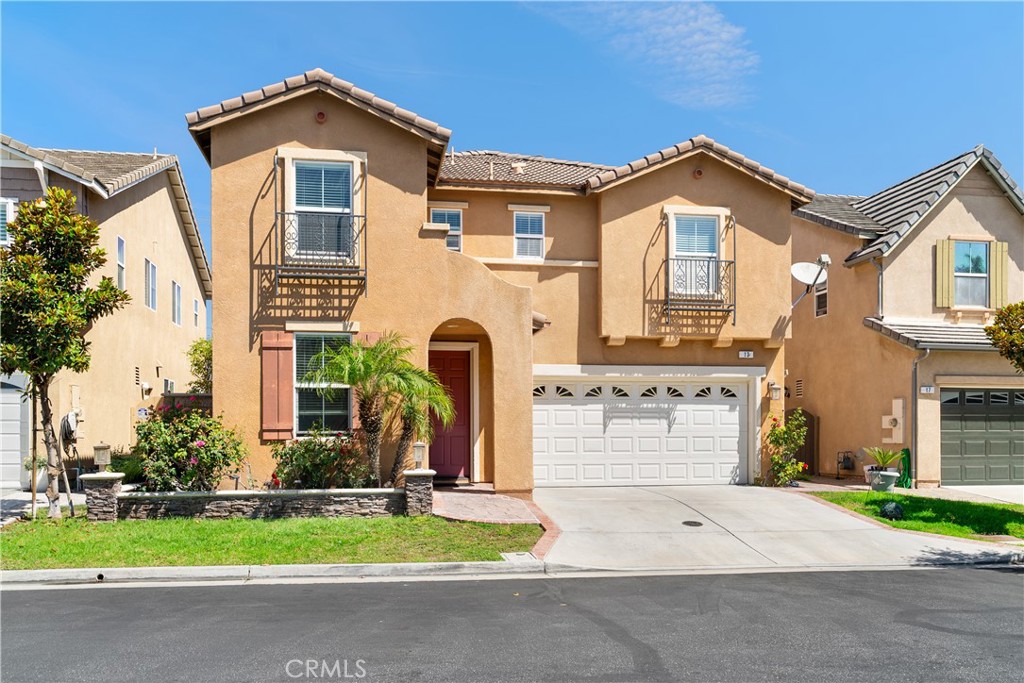 Welcome to this spacious 4 bedroom plus loft, 3 bathroom home in the gated McComber Place community, offering the largest floor plan in the neighborhood. Designed with high ceilings and abundant natural light, the home features a bright living room, formal dining area, and an open kitchen that flows into the family room with a cozy fireplace. A downstairs bedroom and full bath provides convenience for guests. Upstairs, enjoy a versatile loft, laundry room with storage, and an expansive primary suite with dual sinks, soaking tub, separate shower, and a large walk-in closet. Additional highlights include whole house water softener, engineered hardwood flooring, dual-pane windows, ceiling fans, a 3-car garage with 2 Tesla chargers, a landscaped backyard, and an energy-efficient solar system with assumable lease of $122 per month. Residents of McComber Place enjoy resort-style amenities with a pool, spa, basketball court, putting green, playground, BBQ area, and direct gated access to H Mart Plaza. Located in the award-winning Sunny Hills High School, Beatty Middle School, and Emery Elementary District, the home is also conveniently close to shopping, dining, and major freeways.