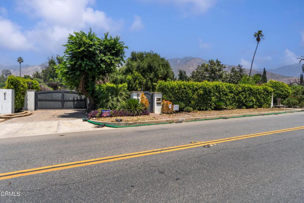 Situated in the estate area of Altadena on a half-acre lot, this premium lot offers an opportunity to build a stunning home on prestigious East Altadena Drive. This private property, formerly a Spanish Revival style estate, boasts a tennis/ basketball court, mature hedges, gated entry, and stunning mountain views. Located near the Altadena Town and Country Club, this lot features a long paver stone driveway, providing a good set back off the street. The property offers a feeling of tranquility with its city-lights views and mountain views. The rear yard offers wonderful entertainment space, including a paved patio, open space for entertainment and recreation. The owner has invested $25,000 in architectural plans for a 3,000 SF Spanish style home. The Army Corps of Engineers has completed Phase 1 and Phase 2. The lot has been fully cleared, setting the stage for new construction. The property is being sold as-is, and the buyer is responsible for conducting their own due diligence regarding future building requirements. This includes consulting with LA County and any applicable agencies. This is a drive-by only listing. Please do not enter the property due to current safety protocols. This is an opportunity to build anew in our beloved and beautiful Altadena. Public records indicate the lost home was 2,626 SF with 4 bedrooms, 2.5 baths, 2-car detached garage. Take advantage of fast track & ADU rebuild rights of up to 10% larger and an attached 1,200 SF ADU atop a 2-car garage.