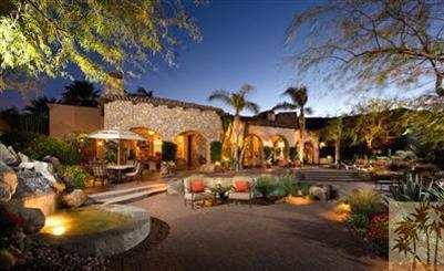 The romance of a Santa Barbara estate with the contemporary feel of high ceilings, disappearing walls of glass and outdoor living at its finest. This home is located on a cul-de-sac, elevated high above grounds of BIGHORN. Views of the Canyons 2nd and 3rd fairways and the city lights of the valley can be seen from the master suite, the living room, the family room, the kitchen, the outdoor living room...plus the entire pool, patio, fire lounge and gardens. Outdoor entertainment area is completely private. This home has four bedroom suites, of which one was remodeled to currently provide a fabulous theatre with full bath. (This room can easily become a full bedroom suite again by changing furnishings.)One of very few homes available in BIGHORN with a full 5-car garage. Second outdoor living area in grotto-style entry courtyard, complete with scenic fresco and fireplace. Detached guesthouse with mini kitchen and laundry facilities. Professionally furnished. Seller may consider trade.