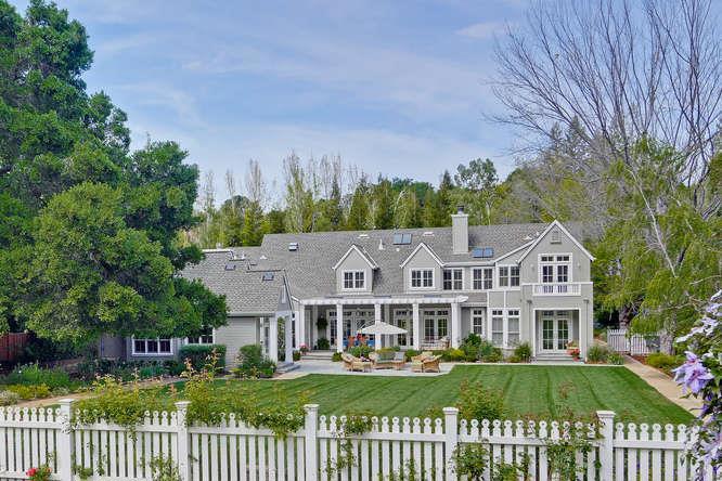 Immaculate 2-story Cape Cod style gated estate situated on 1.26 acres. Entering this beautiful property via semi-circular driveway, you're surrounded by mature trees and lush landscaping. 5,168 sq ft living space includes upstairs playroom ~321 sq ft. Additional attic space of approx. 280 sq ft. Over-sized studio, large great room, 2 laundry rooms, mud room, over 800 sq ft of total covered porch area, plus a 3-car garage and workshop exceeding 1,200 sq ft.