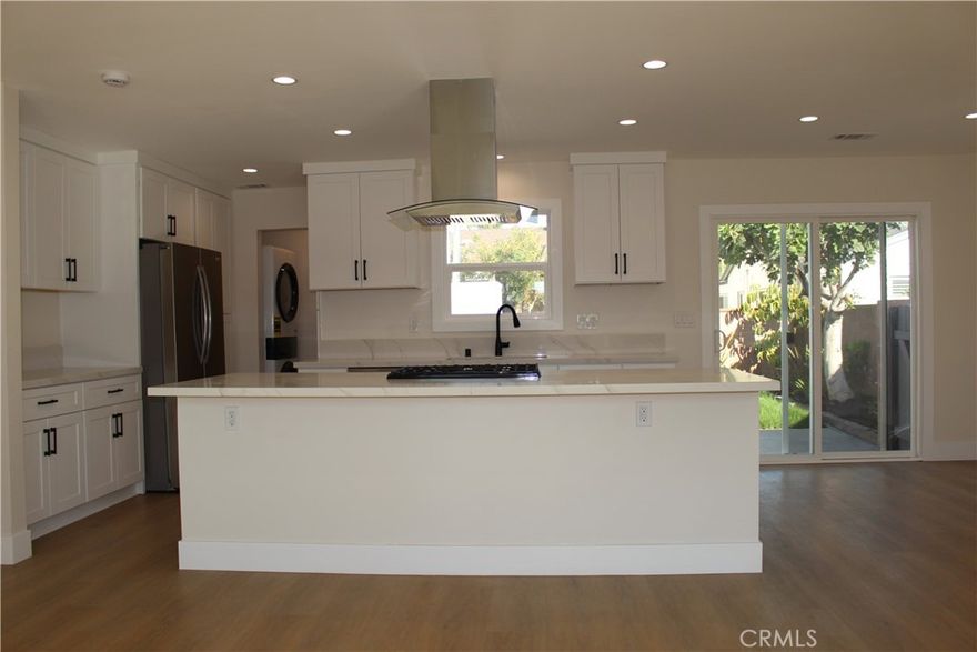 Fully remodeled single family home with 3 well sized bedrooms and 2 full bathrooms.  The open floorplan features a large center island with seating area, stove and uninterrupted views to the dining and living room.  The home has been completely remodeled, with new electrical, new water lines, new plumbing, new luxury vinyl flooring.  Updated kitchen with garden view kitchen sink window, sliding door access to the back patio, great for dining and entertaining.  All appliances, stove, dishwasher, fridge and brand new.  this home has an interior laundry room, with new washer and dryer and storage linen closet. All bedrooms feature center ceiling fans, new mirrored closet doors, new floors and baseboards.  New dual pane windows throughout.  Central AC allows you to keep cool during hot days and the newer heater will do the job during those cooler nights.  The primary bedroom features a backyard view, triple mirrored closet doors, recessed lighting, center ceiling fan and direct access to the loaded primary bathroom.  The primary bathroom features a large walk-in shower with custom tile and glass enclosure, dual sinks, new and upgraded cabinetry and countertop, luxury tile flooring and custom lighting.  The hallway bathroom features a shower over tub combo with glass and tile enclosure, with multiple shower heads.  This gorgeous home features recessed lighting throughout, all new hardware, fixtures, flooring, windows, doors and so much more. The private backyard boasts a cement patio, blockwall enclosed yard, grass area and low maintenance planters.  A full sized, 2 car garage is attached to the home and the convenience of being located a blcik from the 105 freeway and easy access to the 710 & 605 freeways makes any daily drive that much easier.