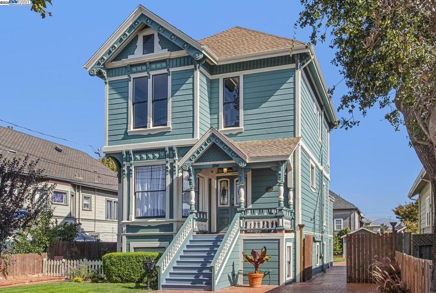 Enjoy the majestic beauty of this 4-bedroom, Alameda Queen Anne in a park-like setting. This fresh, 3000 sq. ft. light-filled home, sits on a large 7,500 sq. ft. lot and has a valuable 3-bedroom and 1-bath attached unit with a private courtyard entrance. Surrounded by lush lawns and classic terra cotta tile, it has 5 off street parking spaces and a long driveway to the rear garage with space for RV parking. The main home retains many original features with impressive soaring ceilings, pocket doors, gingerbread, and more. It features a welcoming formal entry and living room, a sought-after family room, a dining room off the kitchen, and a convenient half-bath. The modern kitchen echoes the architecture of the original home and is designed to be multi-purpose. It is equipped with five workstations, a walk-in pantry, and a laundry room. Amenities include a 6-burner Thermador gas cooktop with a pot filler, built-in oven, dishwasher, large capacity refrigerator, and a center island with an under-counter refrigerator. Picture windows offer an expansive view of the backyard. The second floor boasts 4 bedrooms and a delightful bathroom with a walk-in shower and a claw foot soaking tub. Additionally, there is approx. 660 sq. ft. of useful attic space.