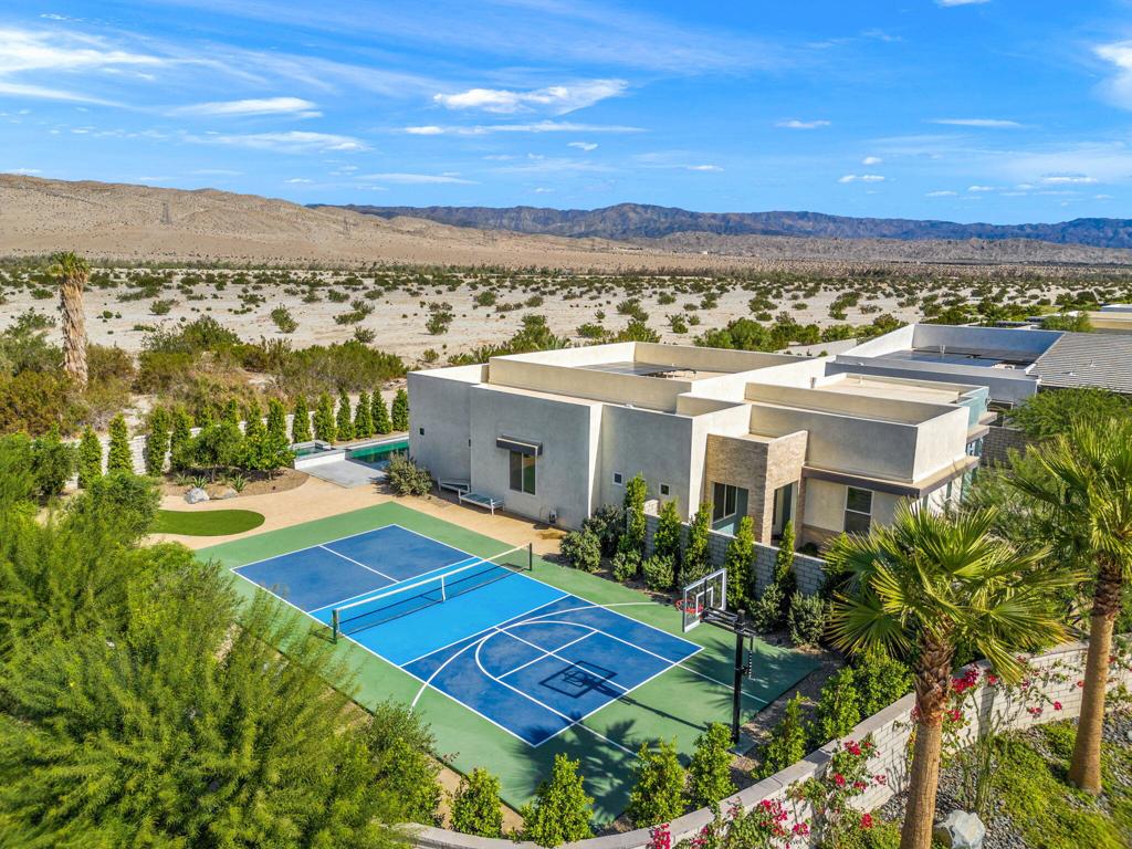 This newer home in Iridium--a boutique community of just 27 modern residences in Rancho Mirage--offers the perfect blend of luxury and comfort. Inspired by the mid-century movement that defines desert architecture, this fully equipped long-term rental is designed to meet all your needs. Step into an open floor plan with soaring 10-foot ceilings, recessed lighting, and expansive multi-slide doors that lead to two private outdoor patios. Enjoy a range of amenities, including a private saltwater pool and spa, as well as a pickleball and basketball court, all set against breathtaking mountain views. This thoughtfully designed home features four bedrooms, ensuring privacy for all. One bedroom has been converted into a spacious, sunlit office. The master suite boasts an oversized shower and a generous walk-in closet, while a second bedroom includes an ensuite bathroom. The gourmet kitchen seamlessly connects to the great room, offering a wet bar, top-of-the-line stainless steel appliances, and an oversized island--perfect for entertaining. Additional high-end features include a whole-home water purification and softener system, bidets in all three bathrooms, a solar energy system, and an optional $10,000 Bodyfriend massage chair. A premium Pioneer sound system enhances both the living room and outdoor patio areas. Ideally situated near premier shopping, dining, golf courses, and outdoor recreation, this home offers the best of desert living.