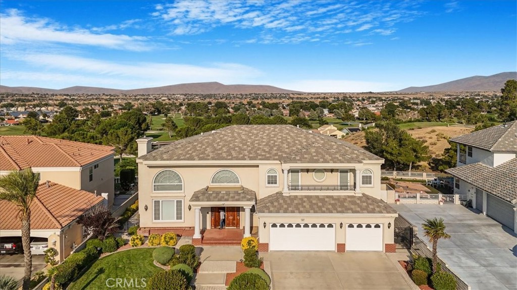 MILLION DOLLAR VIEW!! First time on the market! Stunning Elegant Estate Home in Spring Valley Lake! Situated on a coveted west-facing wind protected expansive entertainers’ backyard of almost 1/3 acre lot, this property effortlessly conveys the resort-style living. Offering Panoramic views of the city, the lake and the prestigious award winning Bear Valley Country Club Golf Course right from your back yard. Built Custom in 1999 by the original owner, this 4,294 sqft home of sophisticated living with tall ceilings, bold architectural details features 5 spacious bedrooms, 4 Bathrooms, 3 with their own en-suite bathroom plus a 3-car garage. The Primary bedroom suite enjoys its own private wing and is a master retreat of its own, accessed thru it’s double entry doors, dual view fireplace, large windows, a corner balcony to admire the luxurious landscaping, a generous size separate sunken tub, dual vanities, separate large walk in spa shower and grandeous size walk in closet. The Entertainers floor plan greets you into a light-n-bright open floorplan, that immediately draws your eye to the fabulous inviting beautifully manicured backyard with ample patio space that is private with a wide grand stairway to a separate green garden area with balcony to the putting green to effortlessly entertain day or night and enjoy the sweeping fairway views and breathtaking sunrises from this 13,500 sq.ft. lot, a seamless flow designed for luxury, comfort and entertainment. The gourmet kitchen has prep center island, separate countertop seating area, granite countertops, stainless steel appliances including a double oven and 6-burner cooktop, Subzero refrigerator and separate adjacent breakfast nook with views. The adjacent family room has a commanding presence of a custom built in bar, tile floors, and more views to the lucious rear yard. Cathedral ceilings and large slider doors grace the formal dining area, which opens to a sophisticated living room. A bedroom and full bathroom complete the downstairs. The dramatic grand welcomed staircase leads to the library with large balcony open to the living room below with a cozy sitting area, conveniently adjacent to the primary suite. The three additional spacious upstairs bedrooms include delightful walk-in closet and pleasant Balcony. One bedroom is conveniently set up for an office with custom cabinetry. The grand Driveway embodies a pristine 3-car garage with built in garage storage system. By appointment only.