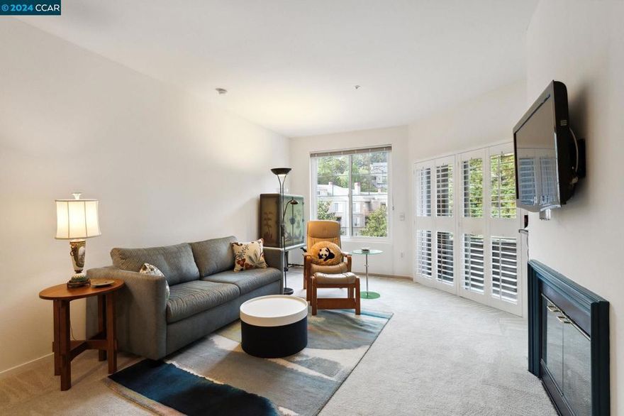 Dramatic Price Reduction! Gracious and spacious! This 2 bedroom, 2 bath condo located in Parkwoods features a great room concept --- an open space combining the living and dining area --- with an expansive view of lush greenery and hillside homes, The Western exposure is an invitation to afternoon sunshine and a peek of lovely sunsets.  Entry from the hall is via the unit’s own open-air atrium.  The living area with a cozy gas fireplace opens onto its personal balcony. The dining area is conveniently adjacent to the kitchen.  The kitchen provides the same view, ample storage, updated counters, a gas stove and a newer refrigerator. The unit is complete with an in-unit washer/dryer.  The primary bedroom suite also opens onto the attached balcony. This bedroom has 2 large closets and a remodeled tile easy-entry shower. The second bedroom near the entrance is convenient to the hall bathroom. It works well as a bedroom or home office. Two parking spaces (in tandem) in the ground-level garage are just steps away from the elevator. The Parkwoods community amenities are complete with a community pool, spa and gym. This gated complex is conveniently located with easy freeway access. Welcome home!