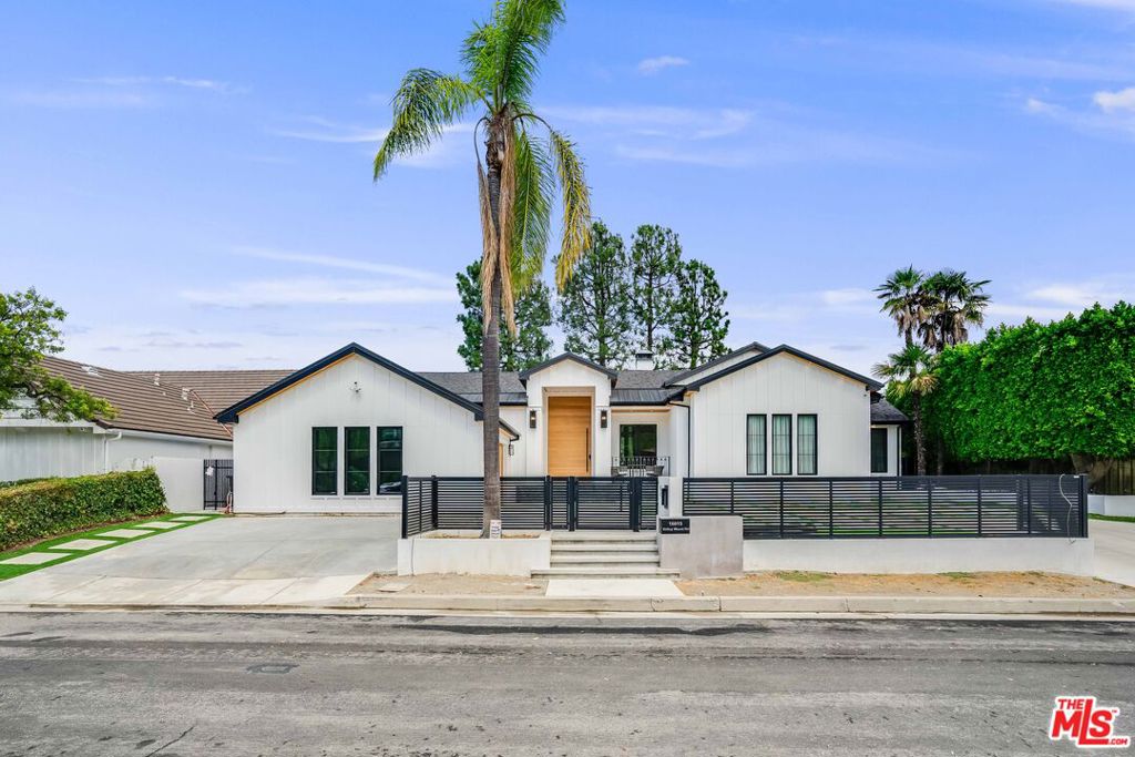 Welcome to 16015 Valleywood Road, Sherman Oaks, an extraordinary 2024 new construction offering seamless modern design, soaring ceilings, and a floor plan built for both entertaining and everyday living.Flooded with natural light, the open-concept living space features floor-to-ceiling glass doors that vanish into a lush backyard oasis with pool, creating the ultimate indoor-outdoor flow. A striking custom wood and stone design anchors the great room with fireplace, while the chef's kitchen showcases sleek cabinetry, oversized island, and professional-grade appliances.The 3,105 sq. ft. residence offers 5 luxurious baths, each finished with designer detail. The primary suite is a private retreat with spa-like bath and serene views. Flexible floor plan allows for guest rooms, office, or gym.Sitting on an 11,545 sq. ft. lot, the property exudes curb appeal with its modern farmhouse, gated motor court, and dramatic entry. Outdoors, enjoy a sun-drenched pool, lounge-ready patio, and total privacy.Located South of Ventura Blvd, minutes to fine dining, shopping, and top-rated schools.