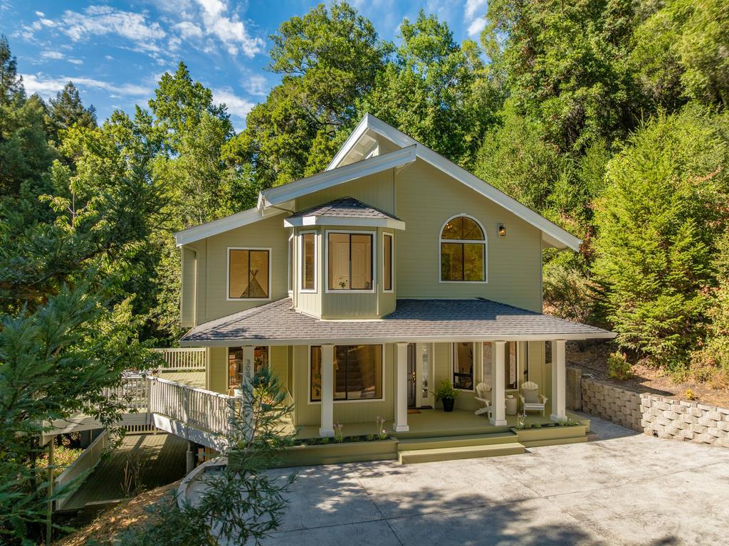 Imagine waking up surrounded by towering trees, where morning light filters through the branches and your commute to Highway 17 takes only five minutes. This refreshed mountain home offers the rare blend of privacy & convenience; sunlit living spaces through south-facing windows below, & quiet, restful bedrooms tucked away above. With southern exposure, every level of the garden thrives, not just for beauty but for purpose, a true paradise for those who love to see things grow. Here, adventure begins at your doorstep. River swimming holes, disc golf courses, & hiking trails don't require weekend road trips, they're simply part of your everyday landscape. Scotts Valley is only ten minutes away, downtown Santa Cruz just fifteen, and Los Gatos twenty. Families find comfort knowing Happy Valley Elementary offers the charm of a small public school with the reputation of a private education. Inside, modern upgrades make life easy: a new furnace, gas fireplace, improved water systems, & thoughtful landscaping. This is mountain living without compromise, tranquility woven seamlessly with valley access. A place where your search for balance finally ends.