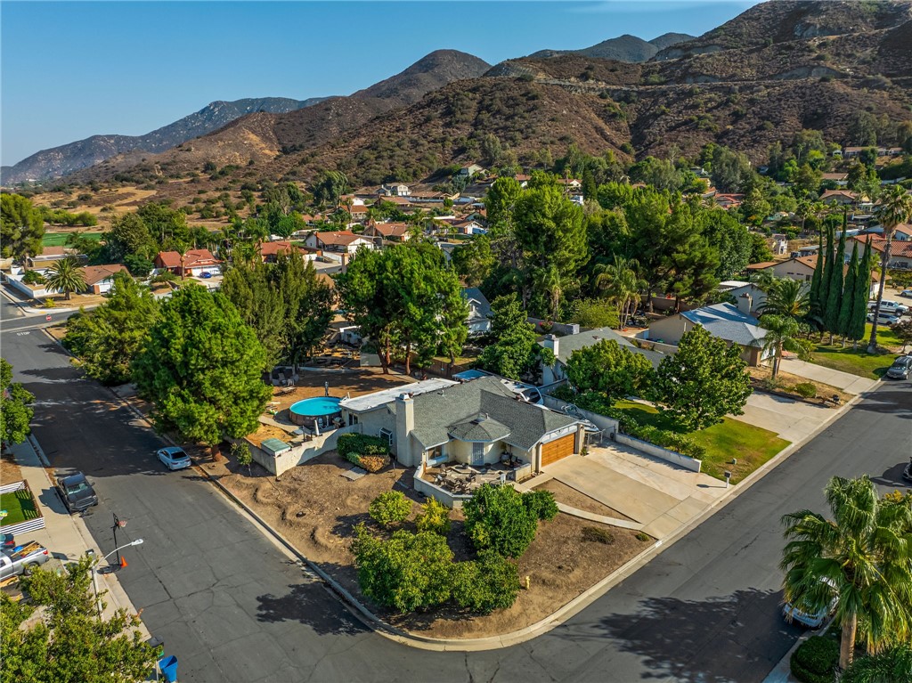 Discover this charming single-story, 3-bedroom, 2.5-bathroom home perfectly situated on a spacious double corner lot. This property is an outdoor enthusiast's dream, featuring a thoughtfully landscaped front yard with a small orchard of mature fruit trees, including avocado, lemon, apple, blood orange, pear, and pomegranate. The expansive backyard is a private oasis, offering a soft-sided above-ground pool, a zip-line, and mature pine trees perfect for a hammock. Additional amenities include dedicated RV parking, a chicken coop (or dog run), and a fenced-off garden with raised beds and a drip system.
Inside, the seamless floor plan leads to a beautifully upgraded kitchen with Samsung BeSpoke kitchen appliances, granite countertops, ample cabinet space, and a large walk-in pantry with a built-in desk. The secondary bedrooms are generously sized and share a well-appointed hall bathroom. The primary bedroom offers plenty of closet and storage space, an en-suite bathroom with a step-in shower, and direct access to a magnificent sunroom. This sunroom spans the entire length of the home, providing a versatile space with built-in cabinets and counter space—perfect for entertaining, crafts, or simply relaxing. The home also has newly painted interior walls and boasts water softener installed with whole house remote water shutoff, updated light fixtures, many modern smart home features, and a two-car garage with laundry hookups and 220V plug installed for an electric vehicle.
Location wise, it is ideal even for commuters as this home offers easy access to Ortega Highway for a quick trip into Orange County.
With fantastic updates, amazing features, and great location, this home is a gem like no other! Make it yours!