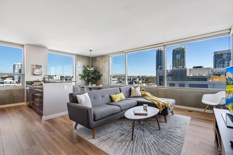 Experience elevated downtown living at ICON, where modern design meets timeless sophistication. This meticulously maintained and upgraded northeast corner residence showcases breathtaking panoramic views of the San Diego Bay, Coronado Bridge, and the sparkling city skyline. Step through the entryway into a light-filled, open-concept floor plan featuring new carpet, wood-look flooring, and fresh designer paint throughout. The gourmet kitchen impresses with stainless steel appliances, sleek granite countertops, and ample cabinetry—perfect for both casual dining and entertaining. The serene primary suite includes a fully built-out closet and a beautifully finished bath with dual vanities. Modern urban comforts include in-unit laundry, two parking spaces, and a private storage unit, providing both convenience and functionality to your downtown lifestyle. ICON is a VA-approved community offering resort-style amenities such as a 24-hour front desk attendant, state-of-the-art fitness center, and the iconic rooftop Skybox terrace with lounge seating, TVs, surround sound, BBQs, heaters, and panoramic city views. Additional amenities include the 5th Inning community recreation room with a full kitchen and business center, a private movie theater, community fireplace, bike and package storage with Amazon lockers, and an interior courtyard featuring sculptural art, a waterfall element, and modern landscaping. Residents also enjoy Google Fiber high-speed internet, on-site property management, and a sleek, contemporary lobby entrance.  ICON is a VA-approved community offering resort-style amenities such as a 24-hour front desk attendant, state-of-the-art fitness center, and the iconic rooftop Skybox terrace with lounge seating, TVs, surround sound, BBQs, heaters, and panoramic city views. Additional amenities include the 5th Inning community recreation room with a full kitchen and business center, a private movie theater, community fireplace, bike and package storage with Amazon lockers, and an interior courtyard featuring sculptural art, a waterfall element, and modern landscaping. Residents also enjoy Google Fiber high-speed internet, on-site property management, and a sleek, contemporary lobby entrance. Explore the best of downtown living—just moments from Petco Park, Gallagher Square, the historic Gaslamp Quarter’s shops and dining, the Central Library, convenient trolley and bus lines, FIT Athletic Club, the Harbor Drive Pedestrian Bridge leading to The Rady Shell, the Convention Center, Seaport Village, Embarcadero Parks, the Coronado Ferry, and more. This home offers the perfect balance of sophistication and vibrant urban energy.