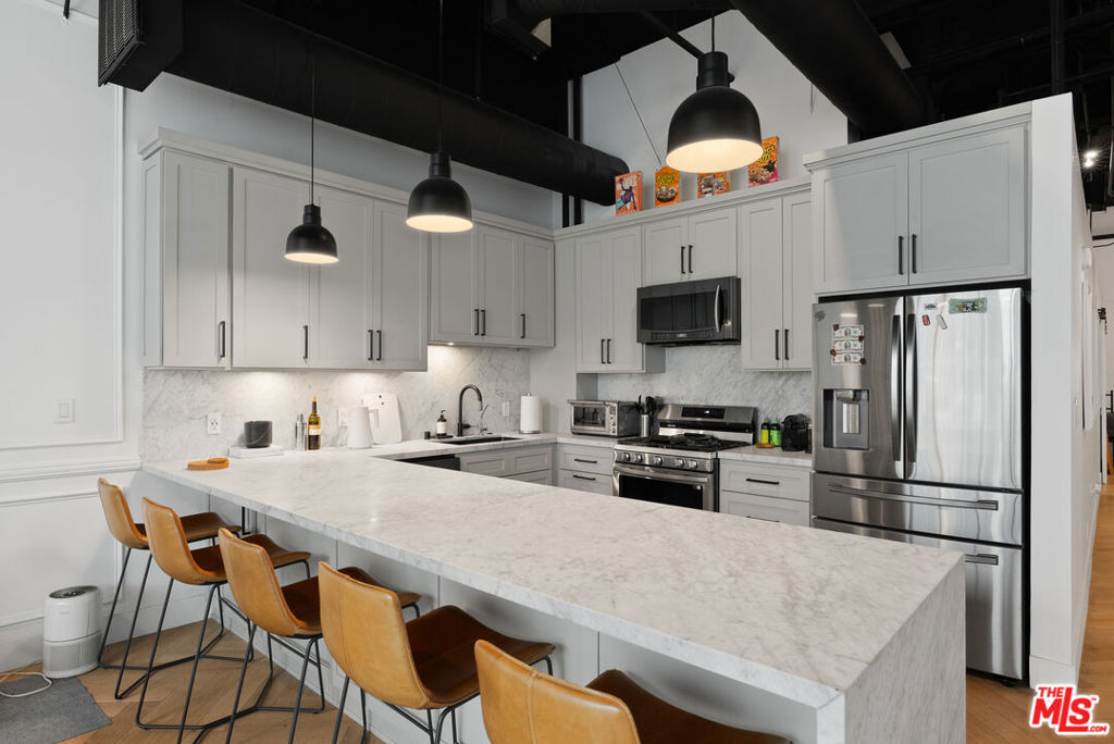 Step into Unit #310, a bright and stylish live/work loft in one of Downtown LA's most sought-after buildings. Enjoy herringbone wood floors, elegant wall detailing, and an open layout filled with natural light and motorized shades. The sleek kitchen features marble countertops and custom cabinetry, while the private bedroom includes wood shutters, extra closet space, and a full spa-like bath. There's also a guest powder room and two secured parking spots included. Moments from Whole Foods, Crypto.com Arena, LA Live, and more. Available furnished or unfurnished!