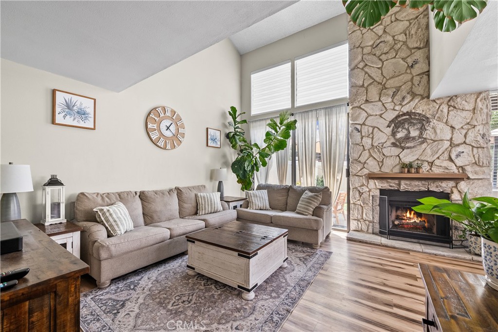 Welcome home to this stunning, fully remodeled 2 bedroom 3 bathroom corner unit with an attached two-car garage and large backyard space and quaint patio off the primary bedroom. This home blends style, comfort, and convenience in every detail. Step inside to soaring high ceilings and an abundance of natural light streaming through large windows. A floor-to-ceiling rock wood-burning fireplace adds warmth and charm to the spacious living room, while sliding doors open to your private patio – ideal for relaxing or entertaining. The newer chef’s kitchen will impress with its sleek modern white cabinetry, quartz countertops, stainless steel appliances, and stylish tile flooring. Upstairs, discover two primary suites, each with its own private bath. One suite features a walk-out balcony for enjoying morning coffee or evening sunsets. Generous storage space is found throughout, making it as functional as it is beautiful. With its prime location, gorgeous upgrades, and unbeatable price, this home is ready for you to move in and make it yours. Don’t wait – this is the one!