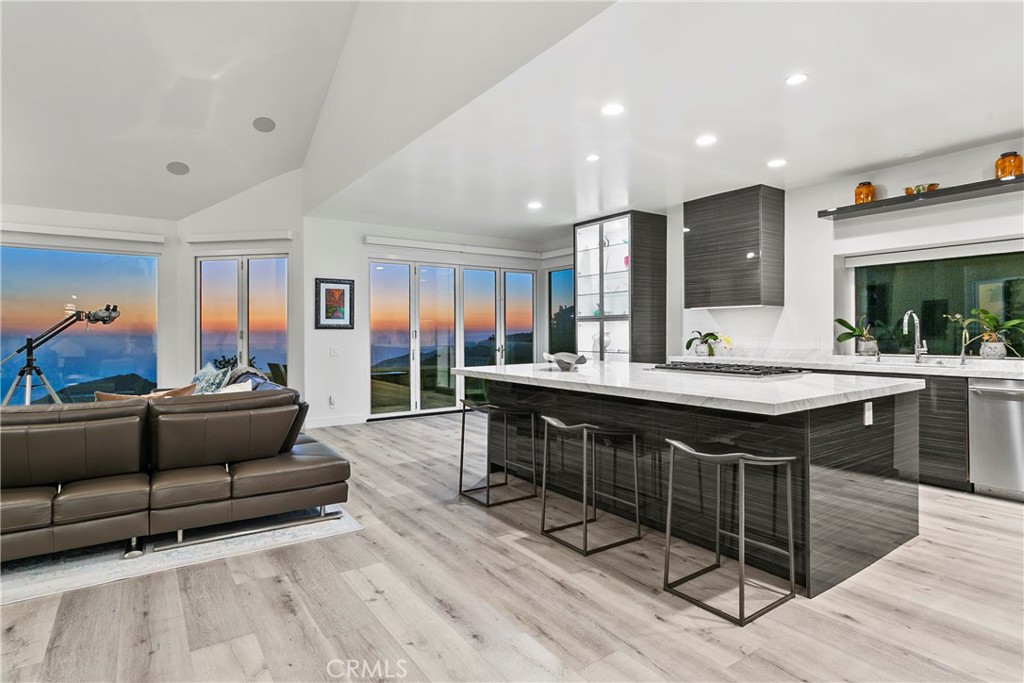 Experience unobstructed panoramic ocean and coastline views , Catalina Island, and sunset views from this luxurious, contemporary Mediterranean home nestled in the prestigious gated community of Laguna Sur. Oversize glass doors frame the dramatic coastal vistas and infuse the open-concept layout with an abundance of natural light and help this entertainer's delight blend seamlessly with the outdoors. Modified from the original builder floorplan to create an open-concept space, the chef’s kitchen opens to the living area and is sure to impress with a 6-burner stove, marble countertops, soft-close custom cabinetry, a wine refrigerator in the kitchen and a walk-in pantry. Enjoy luxury, innovation throughout with soaring ceilings, designer finishes, and smart home features including automation, zoned HVAC with humidity control, a tankless water heater, and energy-efficient appliances. The tranquil primary suite is also modified to create an open concept space, offering a spa-like escape with over-sized custom shower including Mr. Steam steam shower, dual massage showerheads plus rain showerhead, a jetted BainUltra tub, and a generous walk-in closet. Additional features include custom built-ins, whole-home data wiring, integrated surround sound, a central vacuum system, a loft and additional attic and a TONAL Smart Home Gym. Residents of Laguna Sur enjoy exclusive resort-style amenities including two pools, a spa, and 2 tennis/pickleball courts. This prime coastal location is just minutes from the Waldorf Astoria and Ritz-Carlton resorts, the El Niguel Country Club, the charm of Laguna Beach Village, the Dana Point Harbor, and a myriad of dining and shopping options in the newly renovated 'Lantern District' in Dana Point. Badlands and Sea View parks are just outside the gates and offer an abundance of trails and recreational opportunities for the outdoor enthusiast.