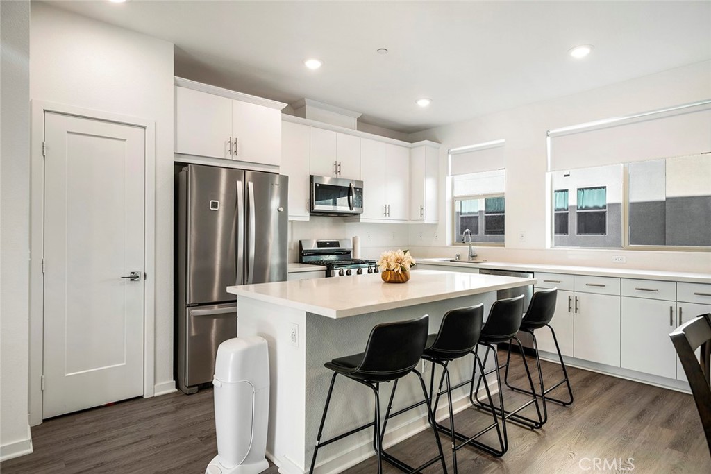 Welcome to this stunning modern tri-level townhouse built in 2023, ideally located in the heart of Covina with excellent access to everyday conveniences and transportation. This thoughtfully designed 3 bedroom, 3.5 bathroom home offers the perfect blend of functionality and contemporary style. The first floor features a private en-suite bedroom, ideal for guests, in-laws, or as a home office. The main living area on the second floor boasts an open-concept layout with a spacious living room, a modern kitchen with stainless steel appliances and quartz countertops, a dining area, a private balcony, and a convenient half bathroom. On the third floor, you'll find two additional en-suite bedrooms, including a spacious primary suite, as well as a laundry room for added convenience. Located just minutes from the 10 Freeway and within close proximity to major supermarkets, Asian grocery stores, restaurants, and retail centers, this home offers a lifestyle of ease and accessibility. With energy-efficient features, including solar that will be paid off when closing, central A/C, and an attached garage, this turnkey property is a rare opportunity you don’t want to miss.