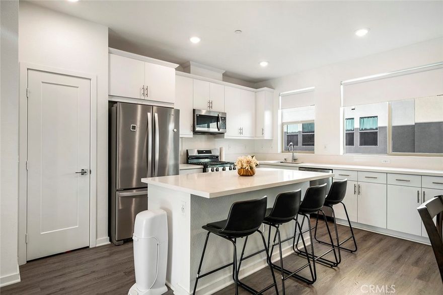 Welcome to this stunning modern tri-level townhouse built in 2023, ideally located in the heart of Covina with excellent access to everyday conveniences and transportation. This thoughtfully designed 3 bedroom, 3.5 bathroom home offers the perfect blend of functionality and contemporary style. The first floor features a private en-suite bedroom, ideal for guests, in-laws, or as a home office. The main living area on the second floor boasts an open-concept layout with a spacious living room, a modern kitchen with stainless steel appliances and quartz countertops, a dining area, a private balcony, and a convenient half bathroom. On the third floor, you'll find two additional en-suite bedrooms, including a spacious primary suite, as well as a laundry room for added convenience. Located just minutes from the 10 Freeway and within close proximity to major supermarkets, Asian grocery stores, restaurants, and retail centers, this home offers a lifestyle of ease and accessibility. With energy-efficient features, including solar that will be paid off when closing, central A/C, and an attached garage, this turnkey property is a rare opportunity you don’t want to miss.
