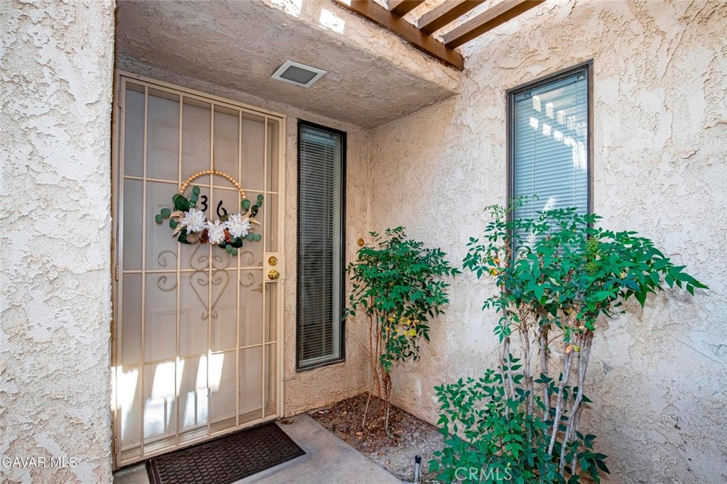 RARE TOWNHOUSE STYLE CONDO WITH DIRECT ACCESS 2 CAR GARAGE. And Gorgeous and in a Gated Community. That's hard to come by! This Lovely Home has been Upgraded with rich Laminate Wood Floors in the Living Room, Bedrooms and even on the Stairs. Tile in all other rooms so Hard Surface Flooring throughout. The Living Room features a newly Updated Fireplace with glass look tile and has slider to the Private Patio. The Kitchen includes updated Stainless Appliances, decorative Tile and plenty of Cabinet Space and opens to the Dining area. There is a Large Indoor Laundry Room and a Half Hath downstairs. Both Bedrooms are very Spacious with Large Closets. Both Bathrooms have been updated with new Fixtures and Decorative Mirrors. Interior Doors are all Raised Panel. You'll appreciate the Central Heat and Air. The Attached 2 car Garage has direct access to the home with an automatic garage door opener. And the Private Patio is Great. It overlooks the Lush Greenbelt leading to the gated Pool and Spa. The HOA fee covers your Water, Trash, Landscaping, the unit's exterior repairs and the structure Insurance. You only have to care for the interior. Don't miss this Lovely Move in Ready Home!