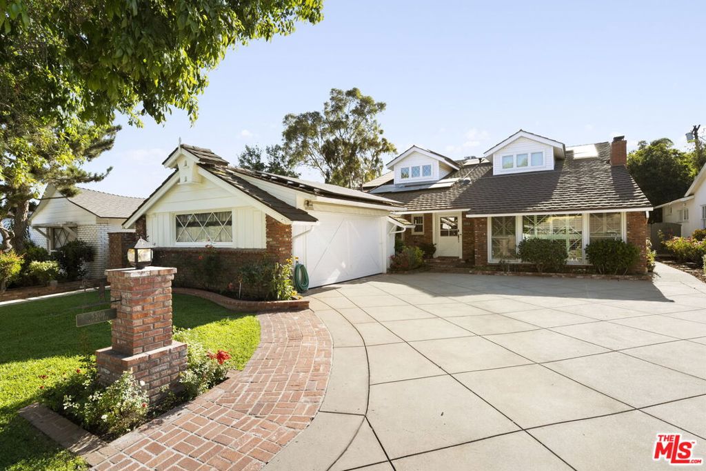 Welcome to 5509 Saloma Avenue - A Classic 1957 William Mellenthin gem in the heart of Sherman Oaks. This rare architectural treasure blends the timeless appeal of Mellenthin's signature design with the versatility of a thoughtfully imagined second-story addition. With approximately 3,420 square feet of living space, this 6-bedroom, 4-bathroom residence offers an ideal layout for both everyday living and effortless entertaining. A cherished family home, it seamlessly combines mid-century soul with modern functionality, offering flexible spaces for multi-generational living, a private retreat, or a creative work-from-home setupall set on a generous 7,448 square foot lot.Curb appeal abounds with signature Mellenthin diamond-paned windows, a cross-gabled roofline, brick-clad faade, and a welcoming brick pathway that leads to a charming front porch. Inside, the home unfolds with warmth and characteranchored by a dramatic double-sided stone-to-brick fireplace with built-ins, wood-beamed ceilings, and expansive windows that fill the interiors with natural light.The formal dining room is equally inviting, featuring a cozy brick fireplace, wood-paneled wainscoting, and French doors that open to a covered patiocreating a natural flow for indoor-outdoor living. A built-in bar adds both charm and function, perfect for gatherings and celebrations. The gourmet kitchen and sunlit breakfast area maintain their mid-century character while offering ample workspace, warm wood cabinetry, and an intuitive layout that caters beautifully to the home chef. Upstairs, the second-story addition features a spacious loft-style family room with custom built-ins, a generous second primary suite, an additional full-sized bedroom that mirrors the scale of the upstairs suite, and a sun-filled kids' room with pitched ceilings and treetop views. The thoughtful layout offers comfort and flexibility, with room for everyone to spread out and feel at home. Downstairs, the remodeled main-level primary suite includes a spa-inspired bathroom with dual vanities, a glass-enclosed shower, and generous double closet space. The layout also features an additional downstairs bedroom, ideal for guests or extended family, along with a full hall bathroom and a conveniently located powder room. A dedicated home office with double closets adds versatility for today's lifestyle needs.Outside, the backyard is a true oasislushly landscaped with a sparkling pool and spa, tranquil waterfall feature, and multiple lounging and dining areas ideal for entertaining or unwinding. A unique feature of the home's rear exterior is its rustic wood design, intentionally crafted to reflect the family's beloved Montana homebringing a sense of warmth and retreat to the space. Whether relaxing poolside or dining under the covered patio, the backyard delivers an inviting atmosphere with timeless character. Located on a peaceful, tree-lined street in one of Sherman Oaks' most sought-after neighborhoods, 5509 Saloma Avenue offers a rare opportunity to own a piece of Los Angeles architectural history thoughtfully expanded and lovingly maintained for the next chapter.