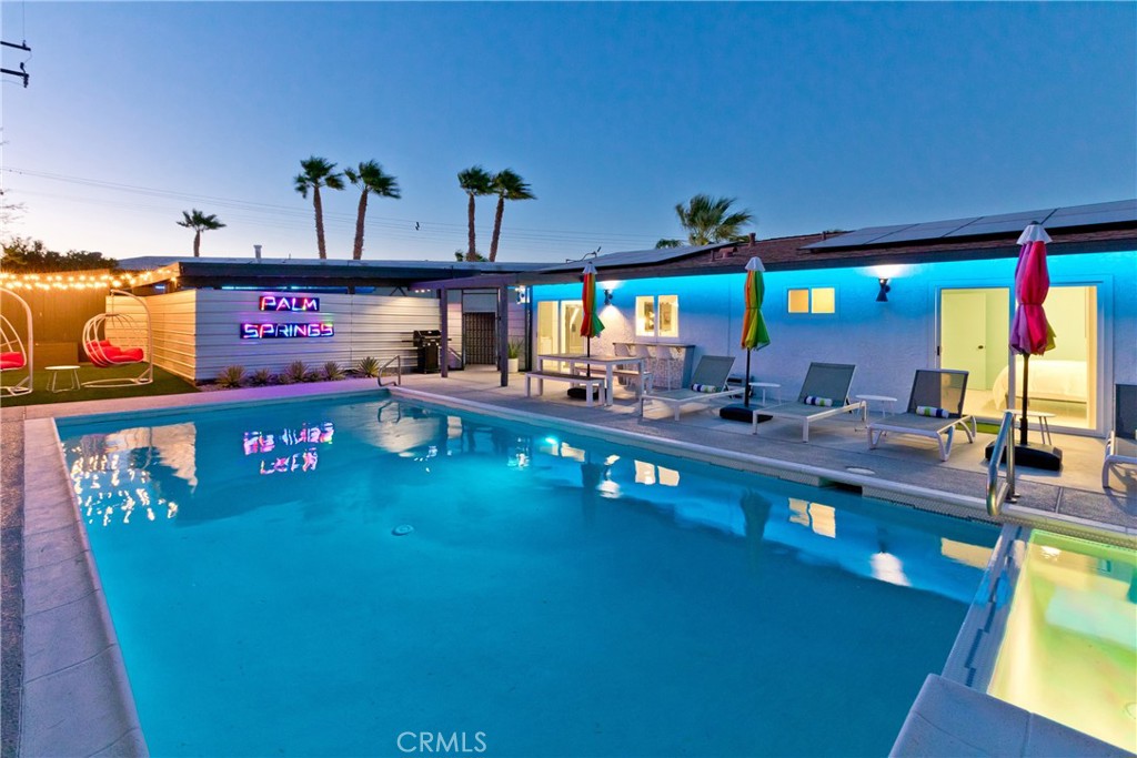 Where Retro Vibes Meet Modern Luxury
Bask in the golden glow of Palm Springs living with this sun-drenched, meticulously reimagined Mid-Century masterpiece — fully remodeled in 2023 into the kind of showstopper that could make Sinatra himself raise a martini and nod in approval. Fully furnished and brimming with personality, this picture-perfect poolside haven — complete with an attached casita — is your ultimate desert sanctuary, camera-ready for its close-up.
On your own sprawling, resort-like lot, you’ll indulge in:
A shimmering aquamarine pool with an attached hot tub — perfect for those dreamy golden-hour dips
A refreshing open-air outdoor shower, flickering fire pit, elegant alfresco dining patio, and lush, low-maintenance turf
Striking desert landscaping framed by jaw-dropping mountain vistas — and at night, the twinkling lights of the Palm Springs Aerial Tramway put on an exclusive show just for you
Generous off-street parking with ample room for your camper or RV
Inside the main home, it’s cool, clean, and completely curated for style and comfort. Underfoot, sleek terrazzo tile gleams beneath a flood of natural light. The all-new gourmet kitchen is a chef’s dream, featuring soft-close cabinetry, charcoal-hued granite countertops, a 36" professional gas range, an under-counter ice maker, and a retro-inspired passthrough window that swings open to the outdoor bar — perfect for cocktail hour under the desert sky.
All-new HVAC, a tankless water heater, and designer-selected fixtures keep your comfort high and your maintenance low.
The showstopper? The attached private casita — a luxurious retreat with its own fully outfitted kitchen (quartzite counters + vintage-style appliances), a light-filled living room, and a primary bath dripping in Hollywood glamour — complete with a freestanding pedestal tub and an oversized spa-like shower.
Located just minutes from the buzz of downtown Palm Springs — whether by bike, foot, or classic convertible — and with quick access to I-10 via Hwy 111, this address blends vintage allure with modern-day convenience.
Whether you’re hosting a full cast of friends or seeking a private hideaway between red-carpet premieres, this 2023-remodeled mid-century stunner is ready to steal the show.