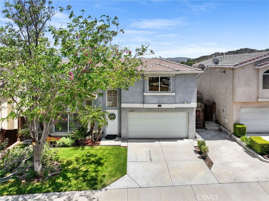 Step into this inviting 4-bedroom, 2 ½-bathroom detached home, ideally located in the highly sought-after Castaic Oaks neighborhood just off Parker Road. Bathed in natural light, this home features a spacious, open layout with soaring vaulted ceilings. Upon entry, you’re greeted by a stunning custom wrought iron staircase, adding an elegant touch and setting the tone for the rest of the home. The main level boasts beautiful flooring, crown molding, a cozy fireplace, and a versatile bonus room that can be used as a formal dining area, home office, or den. The kitchen is equipped with granite countertops, stainless steel appliances, a designer tile backsplash, a breakfast bar, and a walk-in pantry, all flowing seamlessly into the family room with a built-in entertainment center and direct access to the backyard. Step outside to a private, low-maintenance yard featuring a covered California room and a spacious patio, perfect for relaxing or entertaining. The community pool is just steps away, providing the perfect escape on warm summer days. Upstairs, the expansive primary suite offers a walk-in closet and an en-suite bath with dual sinks. Three additional bedrooms provide ample space, natural light, and scenic views. A full guest bathroom is conveniently located upstairs, and there’s also a guest powder room on the main floor. Additional features include an attached 2-car garage with direct access and in-garage laundry. The low $180/month HOA fee covers water, front yard maintenance, and access to the community pool and spa. Located just minutes from Castaic Lake, top-rated schools, parks, and major commuter routes, this home is an exceptional find in a prime community. Come see it for yourself and envision your future here!