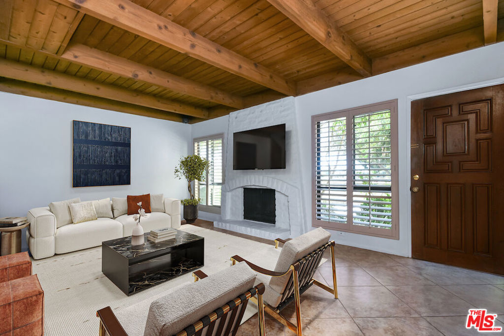 This spacious townhouse features three bedrooms, a den and a welcoming living room highlighted by an adobe fireplace. Floor to ceiling windows with custom shutters providing views of the surrounding greenery and the adjoining park. The dining area situated next to a built in bar, opens via sliding glass doors onto an extra large garden patio with BBQ and refrigerator. The kitchen is thoughtfully designed for convenience, featuring a breakfast area and window that connects directly to the patio...ideal for effortless entertaining. The freshly carpeted upstairs has a primary suite with comfortable sitting room, dedicated makeup table and private balcony with serene treetop views plus two additional bedroom and bath. Additional amenities include a laundry room with generous storage options and a two-car garage enhanced with built-in shelving and a spacious loft offering ample room for extra storage. This family oriented community has a pool and spa with his and hers showers and dressing rooms and ample parking for guests. All of this within minutes to acclaimed restaurants, premier shopping, beautiful parks and top rated schools.