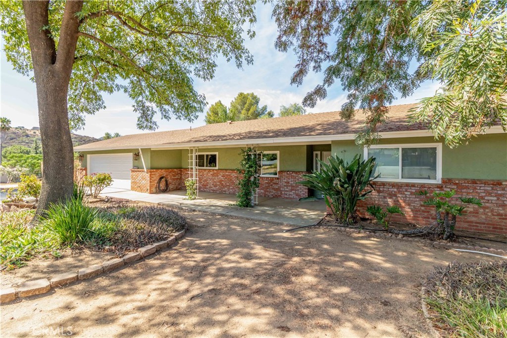 Check out this charming 3 bedroom, 2 bath home with loads of character located in beautiful San Diego Country Estates. Nestled on almost half an acre, have privacy and plenty of room surrounded by mature trees, front and back covered patios, RV parking in the rear, and the Estate’s large hiking and horse riding trails running along two sides of the property. Landscape to your heart’s content by taking advantage of your own private water well with a brand new pump, pressure tank, and control system. Wood laminate floors complemented by travertine in the kitchen, vinyl windows and french doors, ceiling fans in all the bedrooms, and granite kitchen countertops are only one of the many niceties that this home offers. A large stone fireplace as a focal point will be perfect for entertaining, and feel the spacious open-concept design of the kitchen, dining room, and living areas. A bonus room with access to the back patio works great as an office or play room. Don’t forget to take advantage of all the amenities that San Diego Country Estates has to offer including two pools, golf course, pickleball and tennis courts, parks, miles of hiking trails, equestrian center, and restaurant perched above the 9th hole. Head on out and take a look at this competitively priced home and start enjoying country living today.