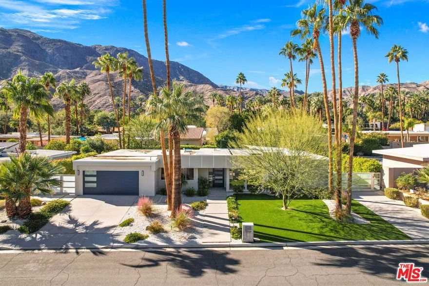 Set beneath the Santa Rosa Mountains in sought-after Magnesia Falls Cove, this beautifully remodeled Mid-Century Modern gem blends timeless design with today's luxury comforts. Offered fully furnished and turnkey, this 3-bedroom, 2-bath home is ideal as a primary residence, desert retreat, or proven investment (consistently renting for $13,500/month in the high season). The light-filled great room features open-concept living with porcelain tile floors, a statement fireplace, and walls of glass with Hunter Douglas electronic shades. The sleek chef's kitchen showcases custom cabinetry, Dekton countertops, high-end appliances, and a large eat-in island. Entertaining is effortless - pass cocktails and appetizers through the kitchen window to the outdoor bar or relax by the fire pit beneath a shaded patio. The primary suite opens directly to the resort-style backyard with pool, spa, and stunning mountain views. Its en suite bath includes dual vanities and a designer-tiled shower. Two oversized guest rooms share a modern bath with a skylight and floor-to-ceiling tile. Outside, enjoy true desert living with a sparkling pool featuring waterfall details, a natural gas fire pit, citrus trees, and a new sun sail for shaded lounging.Additional highlights include: owned solar system for energy efficiency, air-conditioned & tiled two-car garage, smart home controls for lighting, music, and climate. A rare opportunity to own a designer-remodeled Mid-Century home in the heart of Rancho Mirage - perfect for living, vacationing, or investing in the desert lifestyle.