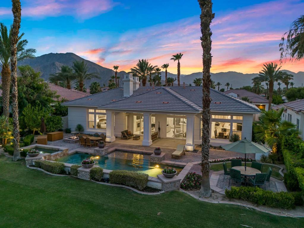 ***Open house Saturday, August 16th from 10AM - 3PM***Experience elevated desert living at its finest at 51464 Marbella Court, an exquisitely upgraded Toll Brothers ''Santa Rosa'' model in the prestigious Mountain View Country Club. This gorgeous estate offers breathtaking double fairway, lake, and mountain views from its elevated location. Thoughtfully remodeled with high-end finishes throughout, the home features honed limestone flooring, and stunning Taj Mahal Quartzite countertops. The gourmet kitchen is equipped with Wolf appliances, a Sub-Zero refrigerator, a Cove dishwasher, and a Sharp microwave drawer, making it a chef's dream. A spacious layout with 4 bedrooms, 3.5 baths, and a versatile bonus room offers ideal comfort for both everyday living and entertaining.The elegant living room, complete with a fireplace and wet bar, flows seamlessly to the expansive covered patio through sliding glass doors, creating the perfect indoor-outdoor lifestyle. Outside, enjoy a private resort-style backyard with a sparkling pool and spa, built-in BBQ, firepit, and lush landscaping. A tranquil courtyard with a fountain and fireplace provides an additional space to relax or entertain. The primary suite is a luxurious retreat with its own fireplace, spa-like bathroom, and large walk-in closet, while the guest suites offer en-suite baths and walk-in closets for ultimate privacy.As a resident of Mountain View Country Club, you'll enjoy 24-hour guard-gated security, social, and HOA-covered front-yard landscaping, cable, and internet. Whether you're seeking a full-time residence or a luxurious desert getaway, this exceptional property offers the best of La Quinta living--move in and start enjoying the lifestyle today. Call today to schedule a private showing.
