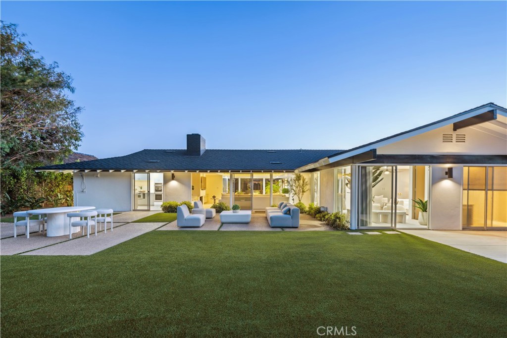 Embodying classic mid-century California architecture, this timeless single-level home is set behind the exclusive 24-hour guard-gated enclave of Monarch Bay. Positioned on one of the neighborhood’s larger private lots, it offers exceptional potential in a highly sought-after coastal community. Recently updated including a new presidential roof, the residence is turnkey and livable as-is, with long-term potential to reimagine or expand.
Inside, the airy open floor plan centers around a sunlit family room with vaulted cathedral ceilings and a statement fireplace adding warmth and architectural character. The formal dining area is perfect for entertaining beneath an elegant chandelier, while the kitchen features chic quartz countertops and ample storage. Large openings with sliding doors create a natural flow between indoor and outdoor living, extending the space into the California sunshine. The primary suite serves as a private retreat with a sitting area and direct access to the outdoors, offering a true indoor-outdoor experience. Three of the four bedrooms feature en-suite bathrooms, and all open to outdoor spaces. The nearly 12,000-square-foot flat lot backs to Monarch Bay’s private park with direct gated access, providing a perfect canvas for a resort-style backyard with pool, spa, and custom amenities. Residents enjoy exclusive membership to the private Monarch Bay Beach Club, managed by the Waldorf Astoria, offering beach butler service, coastal dining, oceanfront lounging, and private event space. Convenient access to world-class golf, hiking, Dana Point Harbor, and luxury resorts completes the unparalleled lifestyle.