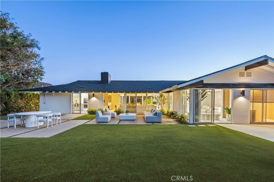 Embodying classic mid-century California architecture, this timeless single-level home is set behind the exclusive 24-hour guard-gated enclave of Monarch Bay. Positioned on one of the neighborhood’s larger private lots, it offers exceptional potential in a highly sought-after coastal community. Recently updated including a new presidential roof, the residence is turnkey and livable as-is, with long-term potential to reimagine or expand.

Inside, the airy open floor plan centers around a sunlit family room with vaulted cathedral ceilings and a statement fireplace adding warmth and architectural character. The formal dining area is perfect for entertaining beneath an elegant chandelier, while the kitchen features chic quartz countertops and ample storage. Large openings with sliding doors create a natural flow between indoor and outdoor living, extending the space into the California sunshine. The primary suite serves as a private retreat with a sitting area and direct access to the outdoors, offering a true indoor-outdoor experience. Three of the four bedrooms feature en-suite bathrooms, and all open to outdoor spaces. The nearly 12,000-square-foot flat lot backs to Monarch Bay’s private park with direct gated access, providing a perfect canvas for a resort-style backyard with pool, spa, and custom amenities.  Residents enjoy exclusive membership to the private Monarch Bay Beach Club, managed by the Waldorf Astoria, offering beach butler service, coastal dining, oceanfront lounging, and private event space. Convenient access to world-class golf, hiking, Dana Point Harbor, and luxury resorts completes the unparalleled lifestyle.
