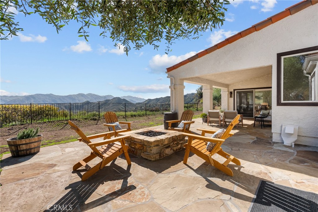 Discover your dream Mediterranean oasis! This stunning 4-bedroom, 4-bath residence boasts unobstructed, breathtaking views of the Santa Monica Mountains and is nestled on over 4 acres of idyllic land, offering nearly 3,500 square feet of luxurious living space. Experience ultimate privacy and serenity, enhanced by a gated entrance, a beautifully designed custom paver driveway, and the tranquil sounds of a gently bubbling creek. Freshly painted inside and out, the interior features soaring ceilings and expansive picture windows that frame the incredible views, inviting abundant natural light to flood the space. This exquisite home showcases breathtaking European Oak Hardwood floors that evoke a sense of warmth and comfort. The elegant formal living room is anchored by a large fireplace, creating an inviting atmosphere for relaxation and entertaining. The dining room is perfectly positioned to offer stunning mountain views, making it the ultimate setting for memorable gatherings. The gourmet chef’s kitchen is a culinary delight, featuring a Sub Zero refrigerator, a professional-grade Viking cooktop, double wall ovens, and a spacious walk-in pantry that caters to all your culinary needs. The main bedroom suite is a true sanctuary, boasting soaring ceilings, two generous walk-in closets, and a private patio where you can unwind with enchanting sunset vistas. Additional highlights include custom-built bookshelves, oversized bedrooms with tailored closets, and a 3-car garage with durable epoxy floors and ample shelving for all your storage needs. A newly installed fence enhances privacy and security, completing this perfect retreat. Discover the exceptional charm of this property, located just a quick 10-minute drive from the award-winning LVUSD school district. Zoned for horses, it offers an exciting canvas for your dreams—imagine building horse stables, an ADU, a refreshing pool, or a welcoming guest house. With a dedicated storage unit included, the possibilities are limited only by your imagination amidst the stunning raw landscape. Embrace the potential and create your ideal retreat!