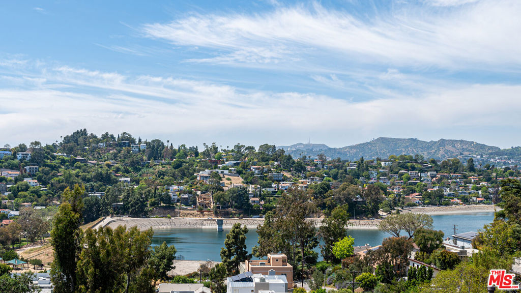 Newly remodeled unit 1915 1/2 to be delivered VACANT at COE. Perfect for Owner-User, Investor or 1031 Exchange! This is an incredible opportunity to own a Spanish-style Triplex in one of Silverlake's most coveted streets offering breathtaking views from two units. The front unit is a split-level 2BR/2BA apartment featuring a wood-burning fireplace, a large open cook's kitchen, refinished wood floors, and an upgraded bath that opens to a beautifully landscaped patio and front yard. The middle unit is a west-facing 2BR/2BA that boasts spectacular sunset views and exemplifies California's indoor/outdoor living at its best. It features an approx. 1000 sf deck with 180-degree views of the Silver Lake reservoir, Hollywood sign, Griffith Observatory, and more. This unit also features beautiful wood floors, spacious interiors with high ceilings, and a wood-burning fireplace. The back unit is a newly remodeled 2BR/3BA with a large bonus room ceiling beams, incredible views from the primary and living room with a balcony, and a lovely open kitchen. All three units come equipped with washers/dryers, and central air and heating. This triplex has been meticulously maintained and upgraded for a discerning Buyer. It is conveniently located near trendy restaurants and excellent shopping in prime Silver Lake.