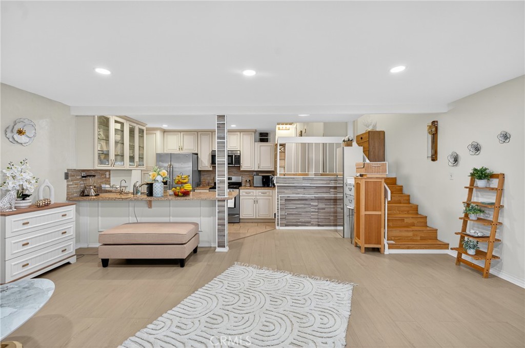 *20k Grant available for property* Welcome to Taos West! Unit #77 is a well-maintained, chic end unit tucked farthest from the main road, offering extra privacy and peace. This 3-bedroom condo features a custom luxury kitchen, abundant natural light, private patio, and new energy-efficient HVAC—move-in ready. With 1,117 sq. ft. of living space in the heart of Panorama City, the open floor plan includes a spacious living area with recessed lighting and elegant wood flooring. The custom kitchen boasts beautiful cabinetry, ample counter space, and flows seamlessly to a private, fenced patio. Upstairs, generous bedrooms are filled with natural light, ensuring comfort and style. Recent upgrades include a brand-new energy-efficient HVAC, new flooring, fresh décor, and a well-managed HOA. Eligible buyers may qualify for first-time homebuyer assistance through an available grant program, creating an excellent opportunity to purchase in this desirable community.