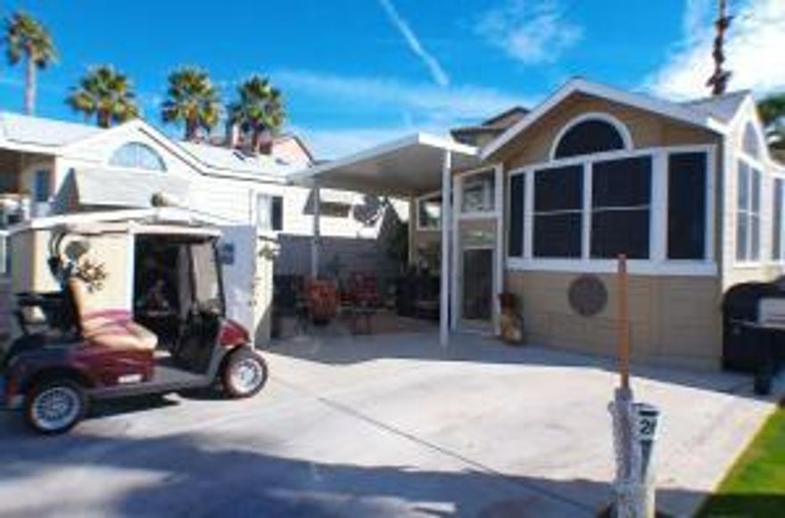 1995 Hallmark Park Model offers a wonderful enclosed deck with a hidden TV cabinet, 2 areas to relax or entertain and a gorgeous garden in the backyard. The ceiling is insulated, 2 ceiling fans and an electric heater with lots of windows. Stepping into the living space you are greeted with laminate flooring, D/W, Refrigerator, Microwave, 30' Stove, ceiling fans, 2 leather recliners and eating area. Down the hallway is a Stacked W/D leading into the bedroom. The Bed is a King-size airbed that has a unique window covering above it. Storage under bed along with drawers and large closet. The patio is between the finished shed and Park Model with lots of space to sit. There is a second fridge in shed along with a desk and floor heater. The Unit also has Summer Window screens to lessen the heat inside. Don't miss this Beauty!