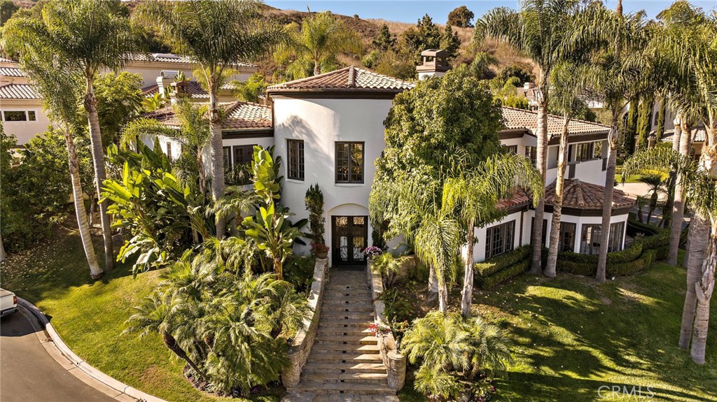 Welcome to 30372 Marbella Vista, an exquisite residence nestled within the prestigious gated community of Marbella in San Juan Capistrano. Spanning almost 5,500 square feet on an expansive 11,000 square foot lot, this luxurious pool home is a perfect blend of elegance and comfort.
This stunning property features 4 spacious bedrooms and 4.5 bathrooms, including a unique downstairs ensuite complete with a full bathroom and a private living room, ideal for guests or multi-generational living. Upstairs, each bedroom comes with its own private bathroom, ensuring ultimate convenience and privacy for every member of the household.
Wine enthusiasts will appreciate the temperature-controlled wine cellar, perfect for storing your prized collection in optimal conditions. The open-concept layout seamlessly connects the gourmet kitchen, formal dining area, and grand living room, making it perfect for entertaining. Large windows throughout the home flood the space with natural light, while high-end finishes and attention to detail add a touch of sophistication.
Step outside to your private backyard oasis, where the sparkling pool and lush landscaping create a serene retreat. Whether you're hosting a summer barbecue or simply enjoying a quiet evening under the stars, this outdoor space is sure to impress.
Situated in the lush rolling hills of San Juan Capistrano, the Mediterranean-inspired Marbella Country Club sets the standard for outstanding amenities and superb hospitality. Blending the time-honored traditions of golf with modern, upscale conveniences, the club boasts an award-winning championship golf course crafted by the iconic design team of Jay Morrish and Tom Weiskopf; an array of golf, tennis, fitness, dining and social amenities; and the personalized service and exclusive privileges that have earned it recognition among the finest private clubs in Orange County. Providing an exquisite backdrop for weddings, corporate events, birthdays, and celebrations of all kinds. The dedicated team ensures a seamless planning process, while bringing your unique vision to life and creating unforgettable memories for you and your guests.
This home offers not only luxury and privacy but also access to top-rated schools, shopping, dining, and easy freeway access. Don’t miss the opportunity to make 30372 Marbella Vista your new dream home.