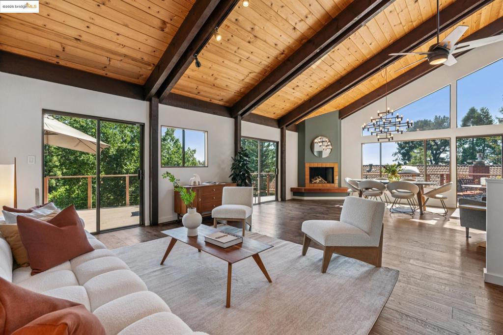 Step inside and feel the wow of Bay views and light. This beautifully updated 4BD/2BA home blends mid-century modern design with tasteful upgrades and all-new systems. Soaring vaulted ceilings, exposed beams, and walls of glass invite natural light and Bay views into the open floor plan. Set in Woodminster, a haven for outdoor lovers, the home offers indoor-outdoor living, a lush, private front yard, a new rear double deck (2024-25), owned solar, dual heat pumps, an EV charger, and a level fenced back yard with an enclosed veggie garden—deer-proof and ready to grow. Two downstairs bedrooms provide flexible space for guests, office, gym, or media room. The split-level layout offers privacy—ideal for working from home or relaxing in peace. The level-in 2-car garage and huge bonus space offer ample room for hobbies and storage.** Close to highways 13, 24, and 580, Farmer Joe’s, Rockridge, Berkeley dining, and canyon trails. A rare mix of style, nature, and comfort .**Buyer to investigate.