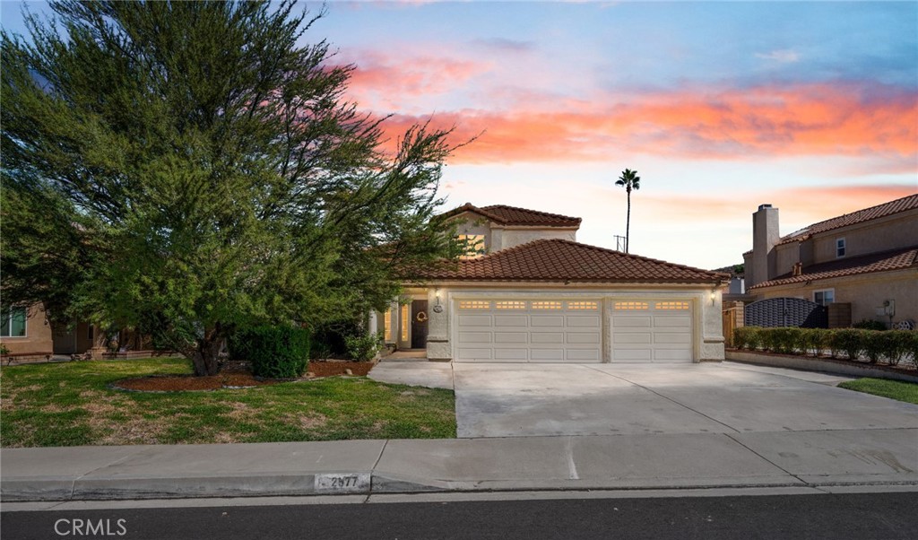 Turnkey home in Reche Canyon Estates with a large garage and a private yard on a quiet cul-de-sac. Enter into a bright living room with vaulted ceilings and light streaming in on four sides. Tile flooring throughout the lower floor living spaces pairs with brand new carpet. Adjacent to the living room is a main floor guest bedroom and 3/4 bathroom. Down the hall is a spacious kitchen; the peninsula opens up to your dining space complete with charming bay windows, and to your cozy family room with an additional gas fireplace. Upstairs are two bedrooms which share a Jack and Jill bathroom with dual vanities. The enormous primary suite has newer LVP and large ensuite bathroom also with duel vanities and soaking tub. A three car garage has converted the third space into a fifth bedroom, convenient for additional guests or multigenerational living. This room has windows, HVAC, and a seperate exterior entrance. In addition, newer systems include a tankless water heater, HVAC system, and dishwasher. A dual pane slider door takes you out to a well curated yard with a covered seating area - great for entertaining. There is also a sizable storage shed. Conveniently located near Loma Linda University Medical Center and less than three miles from I-10 and I-215 freeways.