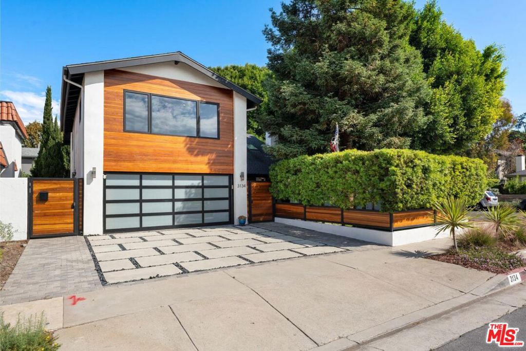 Welcome to a modern architectural gem nestled at the entrance of a quiet Mar Vista cul-de-sac offering a rare blend of bold design, everyday comfort, and exceptional neighborhood connection. Fully renovated down to the studs in 2018, this 5-bedroom, 3-bathroom home captures the essence of refined Westside living, where clean-lined style meets laid-back sophistication and indoor-outdoor flow is second nature. Located within the highly regarded Mar Vista Elementary School boundary, the home sits in a warm, community-driven neighborhood known for its walkability and welcoming spirit. Just blocks away, you'll find local favorites like The Hive, NY Bagel Deli, Pet Express, Chipotle, salons, and everyday conveniences all within a quarter mile. Venice Boulevard's vibrant shops, farmers market, and restaurants are just over a mile away, with Santa Monica College and the Mar Vista Rec Center nearby for arts, events, and year-round recreational programs for all ages. Set on a coveted corner lot, the home welcomes you with a smooth stucco exterior wrapped in mature greenery. A dramatic double-height foyer makes a lasting impression with soaring ceilings, skylights, and gallery-style energy. Sunlight pours through newer windows and sliders, dancing off hardwood floors and recessed lighting throughout. The living room anchors the front of the home with a sleek decorative fireplace and two-story wood mantle, while French doors open to a fenced-in, grassy front yard with eco-friendly turf perfect for lounging, play, or a spontaneous game of catch. At the heart of the home, the chef's kitchen pairs beauty with utility featuring a Viking 6-burner range, double farmhouse sink, pot filler, and an expansive L-shaped island with bar seating. A brand-new refrigerator and dishwasher round out the stainless steel suite, while all systems including HVAC, gas, and electrical were updated in 2018. A dedicated dining area connects the kitchen to the adjacent family room, where stacked sliders open wide to a serene, resort-style backyard. Electric roller shades offer both light control and privacy while maintaining a clean, modern aesthetic. One bedroom and full bath on the main level offer flexibility for guests or a private home office. Upstairs, four additional bedrooms and two bathrooms include a bright, tranquil primary suite with walk-in closet and a spa-like ensuite featuring a freestanding soaking tub and oversized shower. A private secondary staircase leads to a large guest suite, perfect for an office, lounge, creative studio, or multi-generational living. A dedicated laundry room adds practical convenience to the upper level. The backyard is designed for connection and ease. A deep 8.5-foot pool and spa are framed by low-maintenance hardscaping and a generous lounge area ideal for weekend hangouts, impromptu happy hours, or relaxed evenings under the string lights. Mature landscaping and thoughtfully placed trees create a private, peaceful escape. Whether hosting friends or simply unwinding, the seamless indoor-outdoor flow expands the home's usable footprint in all the best ways. The finished two-car garage adds extra versatility with epoxy flake flooring and plenty of storage. With its flexible floor plan, stylish design, and vibrant neighborhood setting, this is a home crafted for connection, comfort, and everyday ease. It's not just a place to live it's where life opens up.
