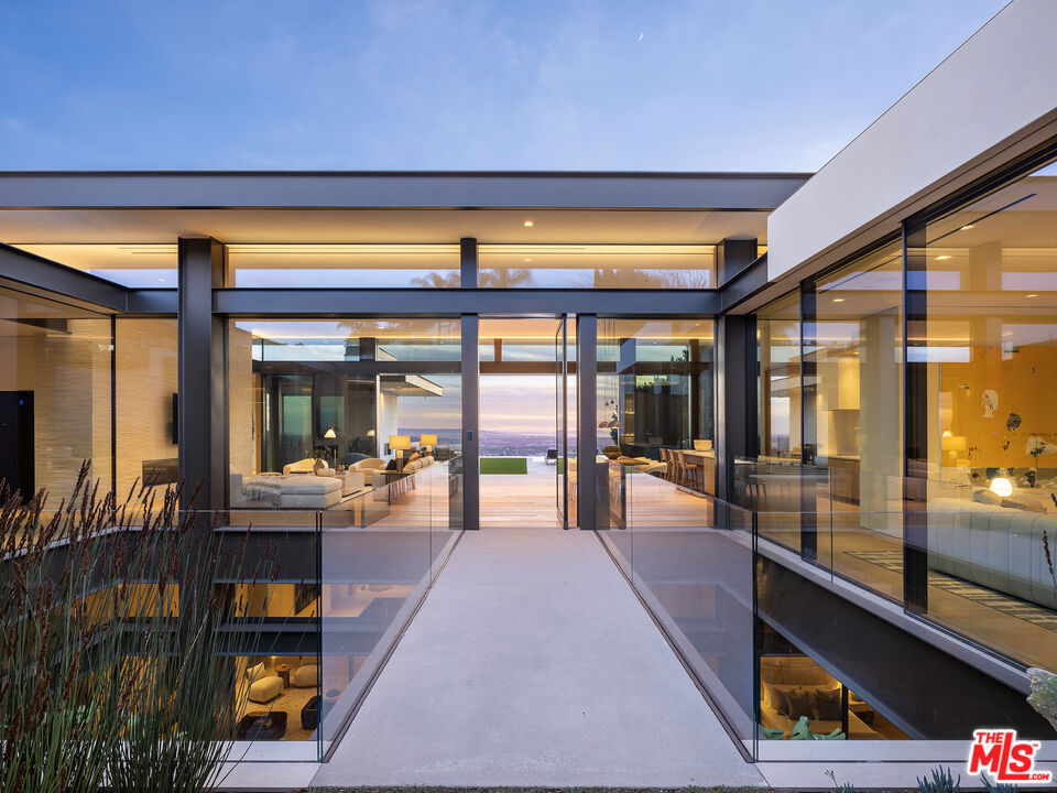 Indulge all of your senses in this brand-new Contemporary marvel located in the prestigious Bird Streets. Showcasing supreme quality with the finest materials, this estate embodies luxurious Los Angeles living and is the ultimate view estate with unobstructed jetliner vistas from Century City to the Pacific Ocean. A masterful creation by Paul McClean architecture, built by Dugally Oberfeld, and interior design and finishes by Marmol Radziner, this home features every conceivable amenity. Spanning approx. 13,400 sq.ft. of living space with 7 bedrooms and 9 bathrooms, there is ample space for friends, family, staff, and entertaining. Offering privacy and security, a gated driveway leads to a subterranean 8-car garage and the gated front entryway leads to the glass front door across a bridge spanning above the lower level interior courtyard oasis. Equipped with state-of-the-art smart home technology and custom automated walls of glass that amplify the incredible views throughout. The main level offers a grand living room with fireplace, dining area, expansive kitchen with enormous island and Wolf and Subzero appliances, family room, powder room, two guest bedroom suites with one furnished as an office, and the beautiful primary bedroom suite with walls of glass and terrace overlooking the views, fireplace, dual walk-in custom closets, and Afyon White Slab marble bathroom. The living room and primary bedroom flow into the exterior space featuring lounging terraces, fireplace, synthetic turf, and zero-edged pool and spa. Descend the floating staircase or take the elevator to the lower level which offers an incredible entertainer's oasis and wellness retreat. Features include a living room with large built-in bar, game/billiard room, glass wine display, gorgeous theater/media room, huge gym with walls of glass to covered patio, and spa with massage room, large shower and sauna. There is also a remarkable interior courtyard Zen-garden with water wall and the most beautiful living wall that brings light and nature inside. The lower level is complete with a guest suite, powder room, laundry room, and two staff suites. Discover this ultimate hillside oasis just moments from the excitement of Sunset Blvd and the best of Los Angeles dining, shopping, entertainment, and nightlife.