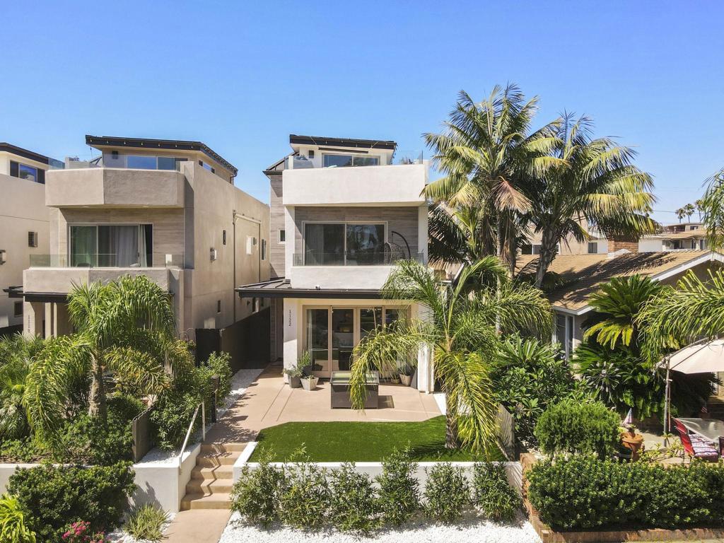Experience modern coastal living at 1122 Oliver Ave. This newly built residence features an oversized rooftop lounge with fireplace and panoramic peek views to Mission Bay. The chef-inspired kitchen boasts shaker cabinets, granite counters, stainless steel appliances, and a striking backsplash. The living room features large cantina doors that completely open the home to the outdoors for seamless indoor outdoor flow. Every detail is elevated with curated fixtures, custom tiled bathrooms, and flexible living spaces. Complete with a private yard and two-car garage, this home blends luxury design with beachside convenience. Ideally located just blocks to Mission Bay, the boardwalk, countless restaurants/ cafes and world class beaches!