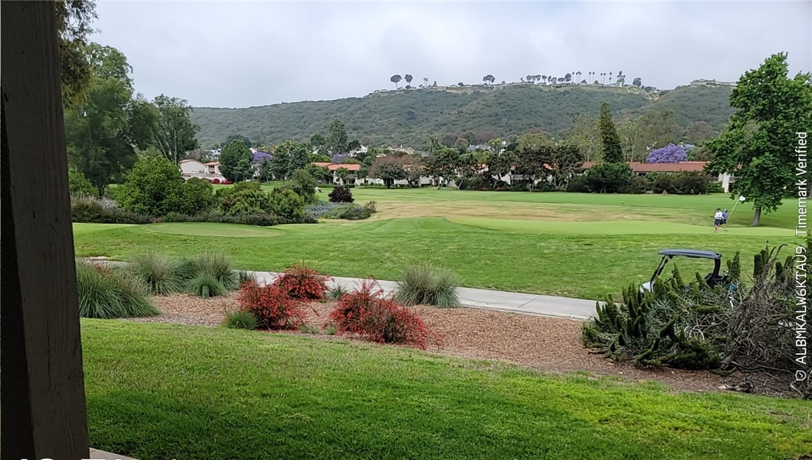 This lower-level end unit condo offers stunning views of the 2nd and 3rd holes of El Niguel Golf Course, with tranquil vistas of the green, fairway activity, and the surrounding valley and hills. Featuring three spacious bedrooms and two baths, the home boasts an open-concept family room that flows into a large patio area complete with a refreshment bar—perfect for relaxing or entertaining. The kitchen showcases oak cabinets with granite countertops, stainless steel appliances including a stove, microwave, and dishwasher, and recessed lighting. Bathrooms feature tiled showers and baths, while the living areas are finished with tile flooring and the bedrooms are carpeted. French interior doors add a touch of elegance throughout. Central air conditioning ensures year-round comfort, and a stackable washer and dryer are included, though their condition is unknown and no warranty is provided. A two car garage is conveniently located nearby, and the community offers beautifully manicured grounds, a pool, BBQs, and picnic tables just steps from the unit. Residents also have the option to join the El Niguel Country Club, Golf Club, Tennis Club, and Swim Club. Located close to beaches, parks, schools, shopping, restaurants, and major freeways, this condo combines peaceful golf course living with everyday convenience. Having been a rental property for several years, the unit presents an excellent opportunity for updates, including fresh paint and new flooring, to restore its full potential. It is being sold in its current "as-is" condition.