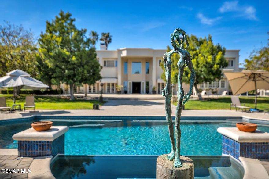 Welcome to Indian Springs Estates, an ultra-private, guard-gated community in Chatsworth, CA, known for its legacy of attracting celebrities, professional athletes, and high-profile executives. With past and present residents including music legend Smokey Robinson, comedian Cedric the Entertainer, and stars from the Dodgers, Lakers, and Rams, this exclusive enclave offers unmatched privacy, security, and prestige. It's no wonder Fortune 500 CEOs and discerning buyers are drawn to the rare blend of serenity and sophistication found here. Set behind the gates of this renowned community, on 3 acres of manicured grounds, lies an extraordinary 11,100 sq ft estate offering 8 bedrooms, 9 bathrooms, and a lifestyle of luxury and refinement. Purposefully designed for elegant entertaining and comfortable living, the home features classic architecture, expansive gathering spaces, and thoughtful details throughout. Italian Calacatta marble, hand-selected from Tuscany, elevates the grand staircase and primary bathroom, setting a tone of timeless elegance from the moment you enter. A hidden chef's kitchen supports household staff and allows for discreet meal preparation and service, keeping the main living spaces perfect for entertaining. Host grand-scale events or intimate gatherings across a variety of formal and informal indoor and outdoor spaces, including a stately dining room, multiple patios, and vast gardens. Resort-style amenities include a full-size, lighted tennis court, indoor gym, and an indoor pool (currently not in use), with additional room for creative transformation. A detached art studio offers the potential for a guest house or ADU conversion. Indian Springs Estates remains one of the most desirable gated communities in Los Angeles. This is a rare opportunity to own an iconic property in a neighborhood celebrated for its exclusivity, beauty, and storied past.