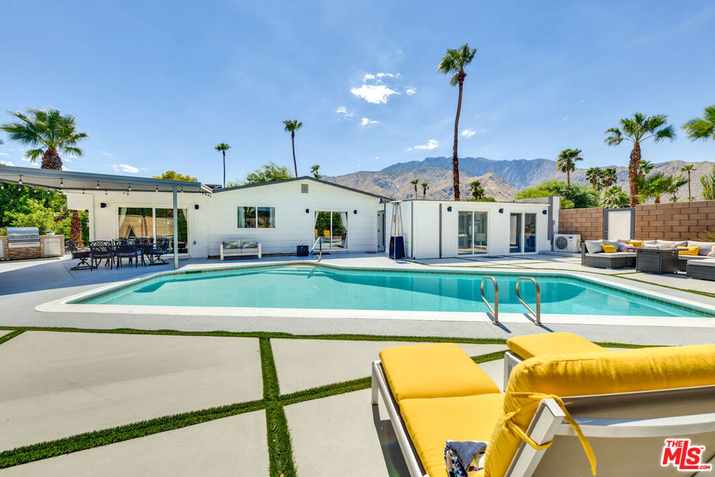 Please do not contact seller. Property has been re-Listed and there is an active listing contract. Modern Palm Springs Entertainer's Paradise! Stunning mid-century modern turnkey furnished 3 bedroom, 3 bath home has a spacious primary suite, and a second ensuite bedroom. With a fully stocked open gourmet kitchen, the den and living areas open out to a covered patio and resort - style tropical pool area. The garage which also opens out to the yard, is decked out with air hockey, a ping pong table and AC/evap cooling, but can be used for cars too! A gazebo covered jacuzzi tub is situated to take in the huge unobstructed mountain view. At night the yard has accent lighting to enhance outdoor cooking at the propane-powered grill, and atmospheric dining under the stars. The home comes furnished and stocked with TVs, books, puzzles, games and a foosball table. The home's smart features include 3 Roku large screen TVs, Nest thermostats, Ring Doorbell, Google Mesh wifi, keypad entries and Remote pool control. The owned solar tames utility costs. With no HOA and situated on fee land (you own it).The current local rental manager has rental history and manages the Air Bnb and its many great reviews of the rental house! The trendy Vista North location makes it easy walking distance to shops and restaurants. Easy to show this wonderful home at any time, call now.