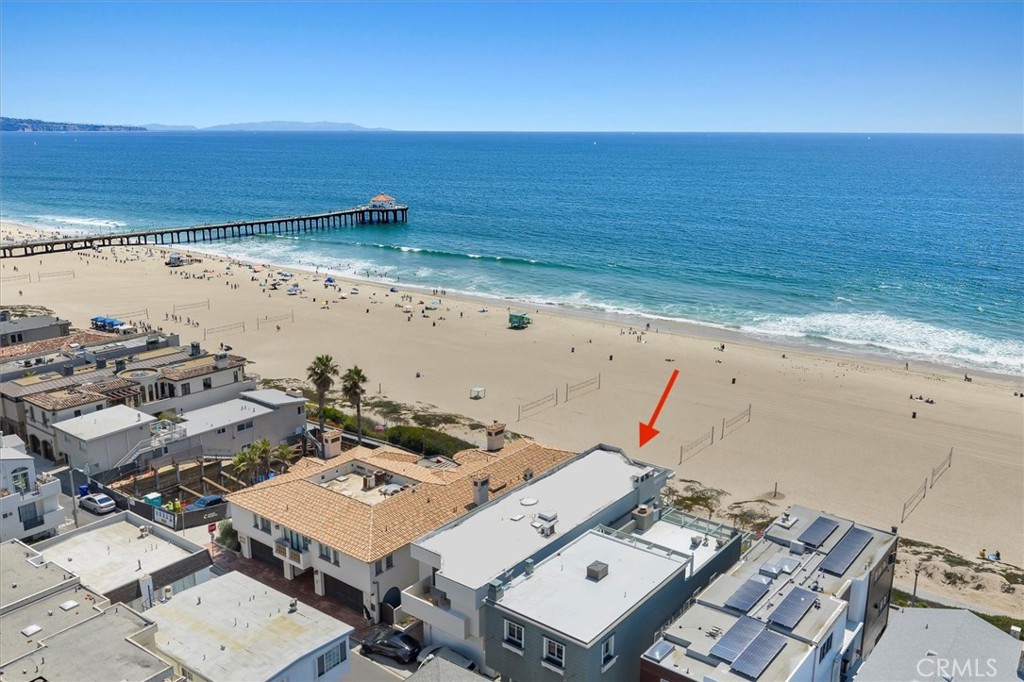 Perched in a premium location along The Strand in Manhattan Beach, this rare coastal estate offers the ultimate in luxury, privacy, and value. Spanning approximately 5,589 square feet over three level floors—all with elevator access, this 5-bedroom, 5.5-bath residence captures breathtaking ocean views from nearly every room. With its elevated position and the unique setback of the northern neighbor, the home enjoys unobstructed coastal sightlines, amplifying both its privacy and panoramic vistas. Inside, you’ll find a layout that’s both functional and elegant. The main level features a formal living room, dining area, and gourmet kitchen outfitted with all-new high-end appliances, including a gas range, double oven, microwave, and Sub-Zero refrigerator and freezer. The beach-side upper level is devoted to a luxurious primary suite complete with a balcony and two separate bathrooms each with their own adjoining closets. On the west end, there are two large guest bedrooms that share a balcony, a guest bathroom, and a laundry room equipped with a new washer and dryer. On the lower level, you can enjoy a spacious beach room with a wet bar, adjoining office/fitness room with its own full bath, a game room, an additional laundry room, a guest suite, and another guest bath. Parking is often a challenge for homes on the strand but here you will find a 4 car garage and just enough room for two additional cars on the driveway. Priced to sell quickly, this is an extraordinary opportunity to own one of Manhattan Beach’s most compelling offerings on The Strand.