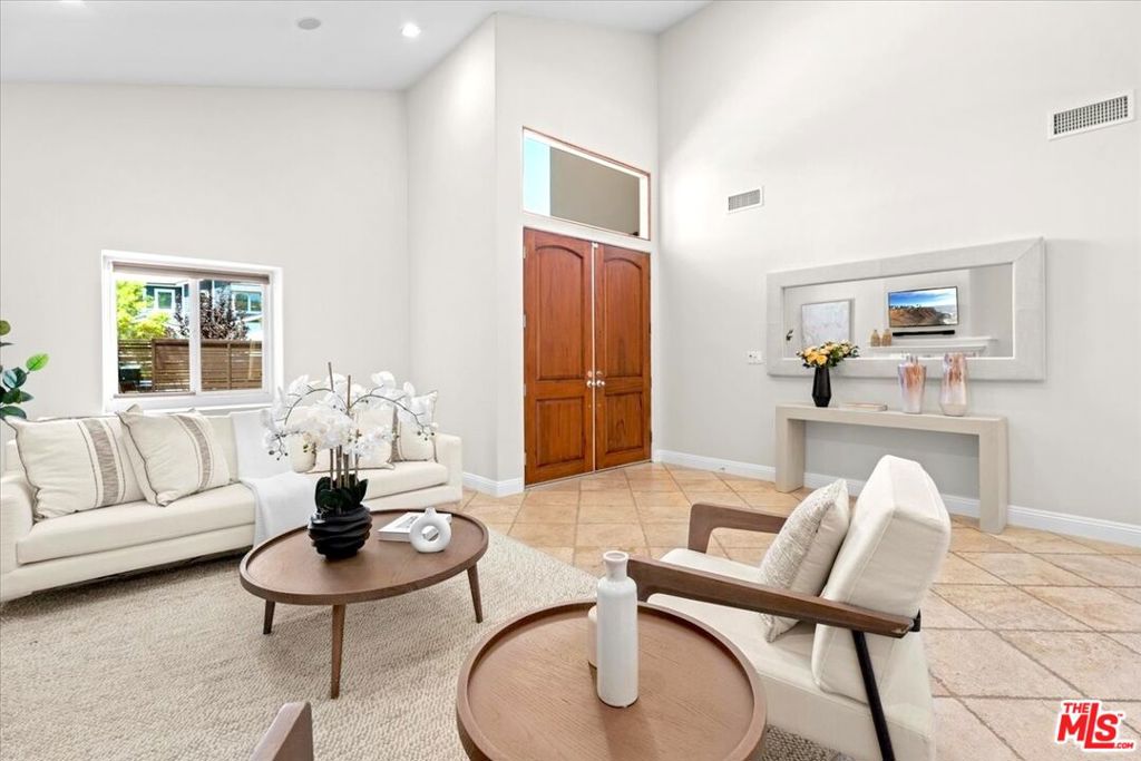 Tucked away on a peaceful, tree-lined street in Sherman Oaks, this inviting home strikes a rare balance between calm suburban living and easy city access. Inside, the layout flows easily, with high ceilings and plenty of natural light making every room feel open and comfortable. Upgraded with practical, forward-thinking features like fully owned solar panels and a backup battery system that even powers EV charging, the house is built for everyday ease. There's a built-in speaker system for music lovers, 4K cameras for peace of mind, and dual-zone climate control to keep things comfortable no matter the season. Step out back to a private yard with smart irrigation and space to unwind. Upstairs, the primary bedroom opens onto a generous deck just right for coffee at sunrise or winding down after a long day. You're only minutes from the buzz of Ventura Boulevard, with great spots to eat, shop, or grab a coffee. Framed by modern iron fencing and secure gates, this home offers both style and substance in one of LA's most loved neighborhoods.