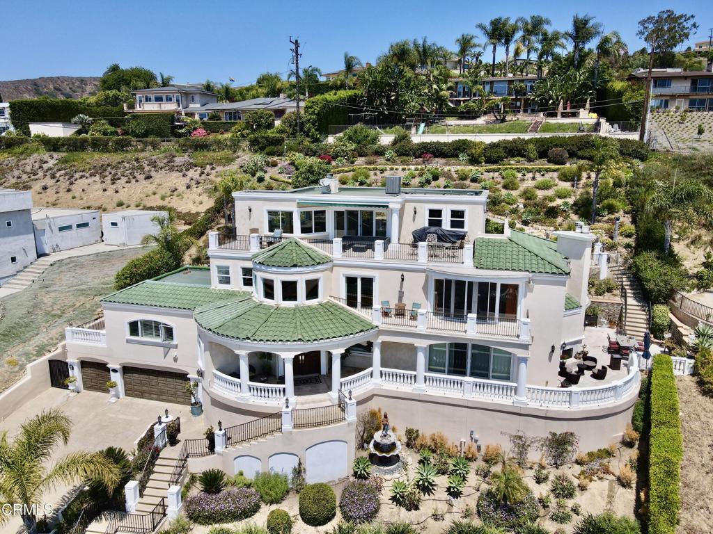 Experience elevated coastal living at its finest from this stunning Mediterranean estate perched atop Ventura's prestigious hillside community.Situated on nearly half an acre, this 4997 sqft residence offers panoramic views of the Pacific Ocean, Channel Islands and sparkling city lights. With 2 large primary suites and two additional bedrooms, spread across two levels and accessible by a private elevator. One of the primary suites is located on the main living level. The grand entry opens into soaring ceilings, stone floors and expansive windows that flood the home with natural light.Large gourmet kitchen with custom cabinetry perfect for entertaining. Step outside to the multiple terraces with sweeping ocean and city views. The outdoor space offers multiple patios ideal for sunset gatherings and entertaining. The back hillside has been terraced and planted and bring plenty of bounty from mature assorted fruit trees. Located in the desirable Poinsettia neighborhood, just minutes from beaches, shopping and top Ventura schools. This is a rare opportunity to own one of Ventura's iconic custom homes