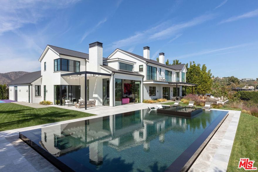 Rare Combination of Ken Ungar Design + Head on City Views. Exquisite Interiors by Adam Hunter. Napa Valley modern farmhouse. High quality construction by Shain Development. Custom in every moment and detail. 9,170sqft+. Excellent floor plan all opening to grounds and views beyond. A soaring 2-story entry and living room to welcome guests. Gourmet kitchen belongs in a showroom. Upstairs features a vast primary bedroom suite with an editorial bathroom that overlooks the city. Total of 7 generous bedrooms and 8 baths. Lower level Entertainment floor offers all the finest amenities including a gym, wine cellar and major screening room. The grounds include an epic zero-edge infinity pool with fire feature, large flat grassy area, and pickleball court. Prime lower Bel Air, minutes to Sunset.