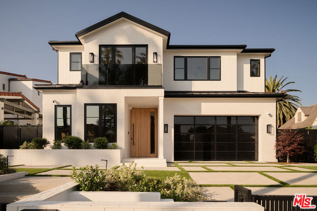 Located in Gillette Square in the exclusive North of Montana area, this brand-new, never-lived-in coastal contemporary home features clean lines and a functional layout. Secured by gates, this elegant residence is designed for entertaining and spans three levels, offering multiple spaces for relaxed indoor and outdoor living. Luxurious details include designer recessed lighting, custom woodwork, natural stone surfaces, LED ambient lighting, and a striking floating wood and iron staircase that serves as an artistic focal point in the heart of the home. The main floor captivates with a designated office, dining room, and the main living space/kitchen seamlessly offering an elevated setting with details such as herringbone wood flooring, custom woodwork on the ceiling, and various built-ins. The living room/family room includes a bar area, wine showcase, fireplace, and large sliding glass doors that open to the backyard. The heart of the home, the kitchen, is equipped with top-of-the-line 2024 Miele appliances, dual islands with natural stone, dual sinks, two dishwashers, LED ambient lighting, a pass-through window to create an indoor/outdoor space, and abundant cabinetry, along with access to the dining room. Upstairs, the breathtaking primary suite, anchored by a fireplace, features an oversized balcony, vaulted ceiling, and his-and-hers walk-in closets. The en-suite bathroom, reminiscent of a five-star resort, includes dual sinks, makeup vanity, a soaking tub, fireplace, and water closet with sink. The second floor also offers three additional bedrooms with en-suite bathrooms and balcony access, providing coastal treetop views from every angle. A stacked washer and dryer next to a linen closet is also found upstairs, easily accessible being adjacent to the primary suite. The basement/lower level is an entertainer's paradise, illuminated by oversized light wells that bring natural light to both sides. This level boasts a secondary living space, temperature controlled wine cellar, full bar with fridge, ice maker, dishwasher, and two 32" TVs. Additional amenities include a gym with a steam shower and built-in TV, and a media room/theater with acoustic walls, an overhead projector, a screen, a surround sound system, and Apple TV readiness. For added convenience, there's a full bedroom with an en-suite bathroom, a half bathroom, and washer and dryer in a spacious laundry room. Outside, the property boasts an entertainer's oasis with a covered patio with two infrared built-in heaters, built-in BBQ area, heated pool and spa, and a backyard with limestone tiles. The ADU/Pool house includes a kitchenette, beverage cooler, 65" TV, a second-floor bedroom with an en-suite bathroom, and a half bathroom on the main level. An alarm system throughout the house and ADU, with multiple keypads, ensures security. With a 2-car garage offering direct access to the home, every detail of this residence has been meticulously curated with no expense spared, from tankless water heaters to smart home technologies accessible at the touch of a button. Situated in the Franklin school district and close proximity to the shops and restaurants on Montana Ave, this home is a rare find, offering exceptional elegance, quality, and top-of-the-line features that are hard to come by at comparable homes this size.