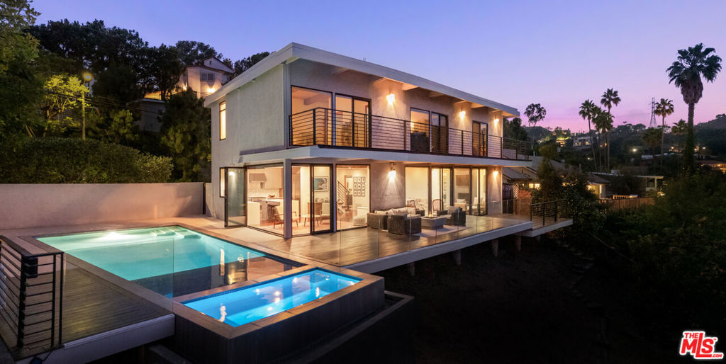 The ultimate entertainer's retreat in the heart of Outpost Estates, this bold and stylish Hollywood Hills home pairs timeless mid-century vibes with modern sophistication framed by some of the most jaw-dropping views in all of Los Angeles. From sweeping city lights to canyon vistas, every corner of this home is designed to showcase the landscape and immerse you in the beauty of Southern California living. With 4 bedrooms and 3 bathrooms, the home delivers clean lines, open living spaces, and seamless indoor-outdoor flow. At its core, a chef's kitchen with high-end appliances and a generous gathering space opens to sun-drenched interiors wrapped in walls of glass. Step outside to expansive decks with sleek tempered-glass railings, an infinity-edge pool with a Baja shelf, and a spa all set against a cinematic skyline. Whether it's a sunset party or a quiet morning coffee high above the city, the setting is pure magic. Tucked in a quiet, celebrity-favored enclave long loved by artists and creatives, this is more than a home it's a lifestyle. A rare opportunity to own a turnkey hillside stunner in one of L.A.'s most iconic neighborhoods.