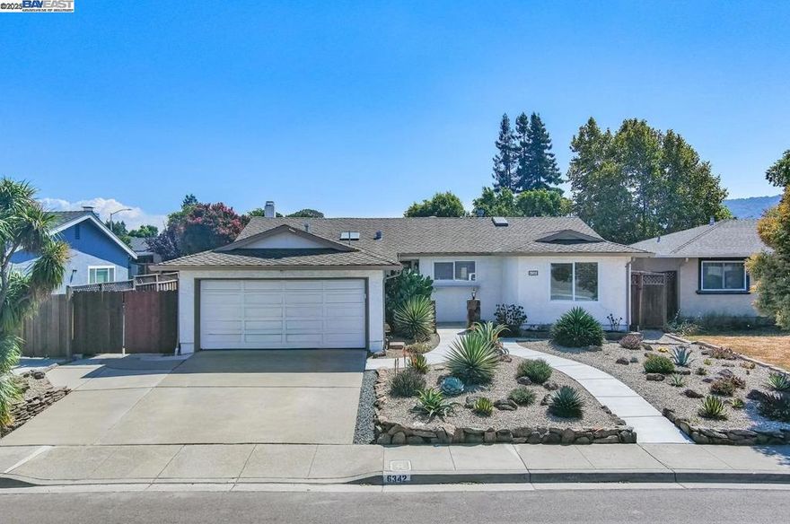 A stunning, low-maintenance landscaped front yard with a charming walking path invites you into this 4-bedroom, 2-bath, 1,603 sq. ft. Pleasanton gem. Inside, an open-concept kitchen, dining, and family room flows effortlessly—perfect for entertaining or everyday living. The chef’s kitchen shines with granite countertops, stainless steel appliances, a wine fridge, double sinks, and endless counter space, while skylights and recessed lighting fill the space with warm, natural light. Generous pantry and storage keep everything beautifully organized.  Beautiful hardwood and tile floors extend throughout the home, guiding you to a private, serene backyard with a low-maintenance patio—ideal for gatherings or quiet afternoons—plus RV parking and solar panels for modern convenience.  All of this just steps from downtown Pleasanton’s shops and restaurants, parks, and top-rated schools—where comfort, style, and effortless living come together in one exceptional home.