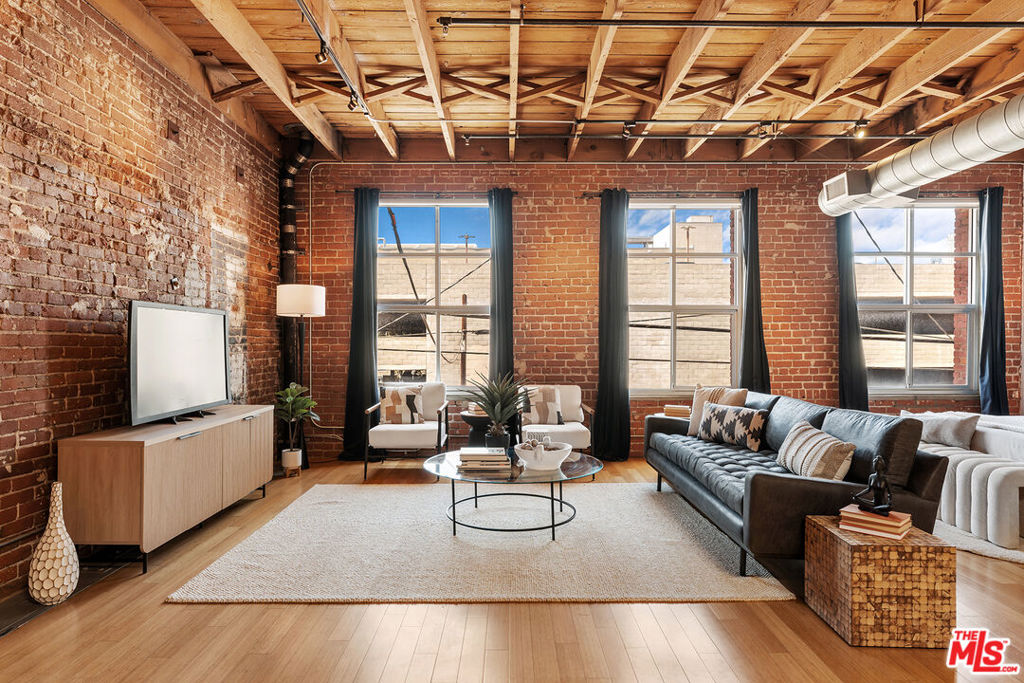 PRICED TO SELL!! Experience urban living in the heart of the Arts District at the Molino Street Lofts. This open concept loft, housed in a beautifully converted 1920's warehouse, offers a unique blend of industrial charm and modern comfort. Exposed brick walls and original wooden beams add character and warmth, while expansive windows flood the space with natural light. The loft's open floor plan provides ample space for both living and entertaining, creating a versatile and inviting atmosphere. With its prime location, this loft offers easy access to the vibrant arts scene, trendy restaurants, and eclectic boutiques that define the Arts District. Embrace the energy and creativity of this historic neighborhood while enjoying the convenience and character of this remarkable loft.